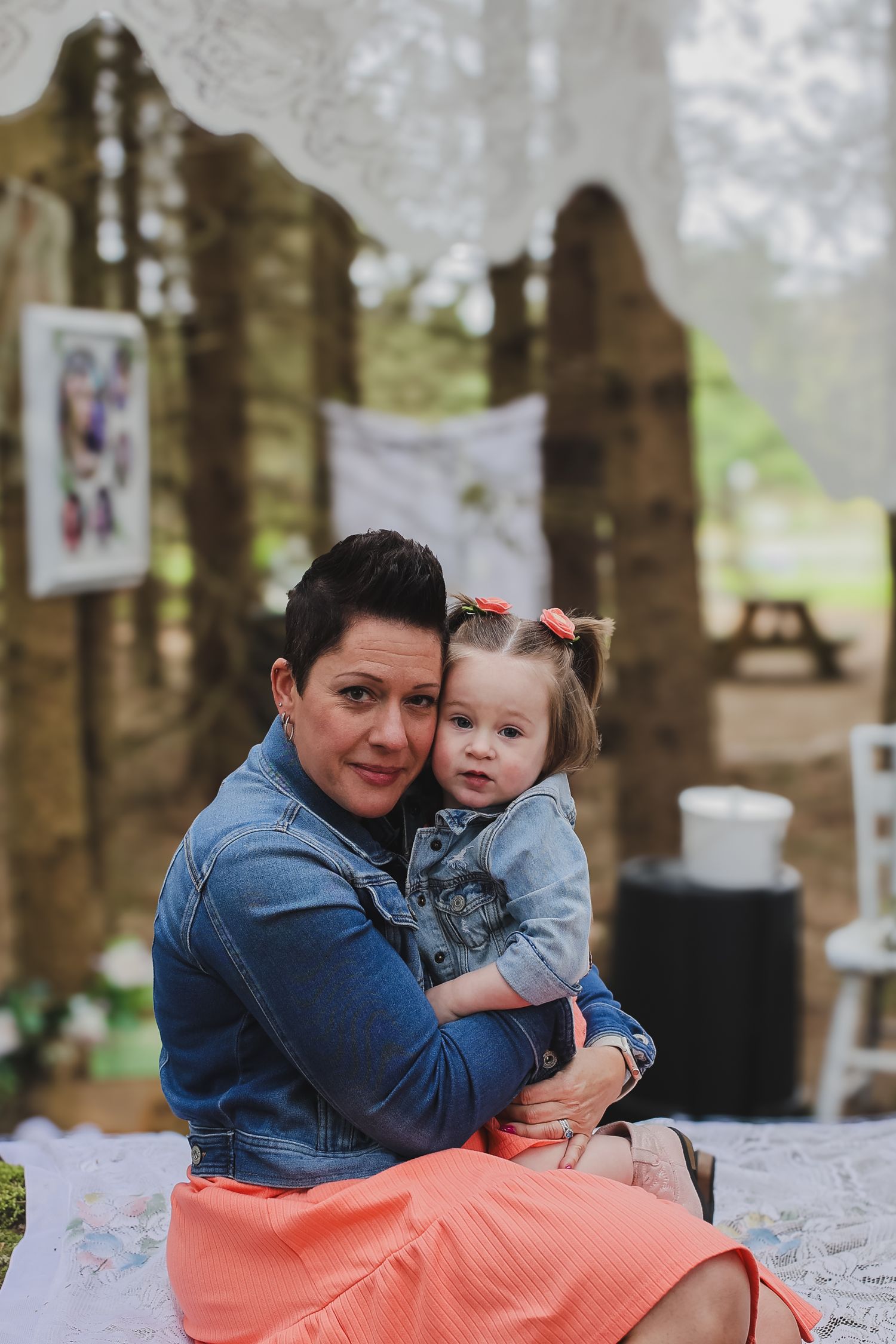 A parent and child share tender moments on a white blanket outdoors in a series of connected photos.