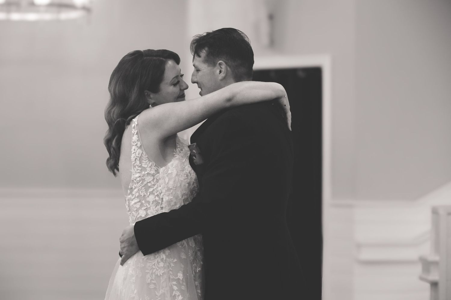 Black and white wedding photo series showing romantic moments between newlyweds during their special day.