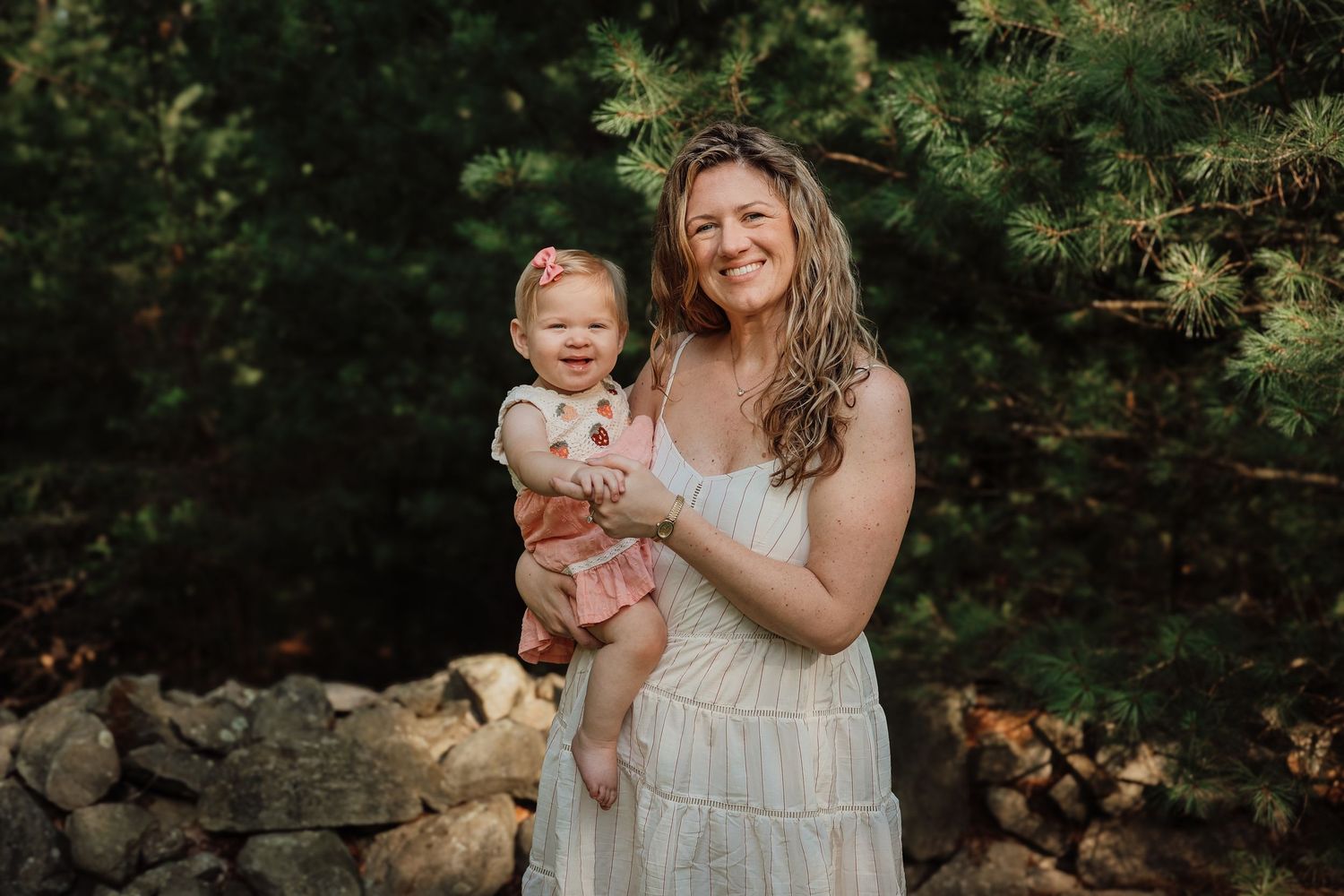 A series of outdoor family portraits showing tender moments between parent and child in a natural wooded setting.