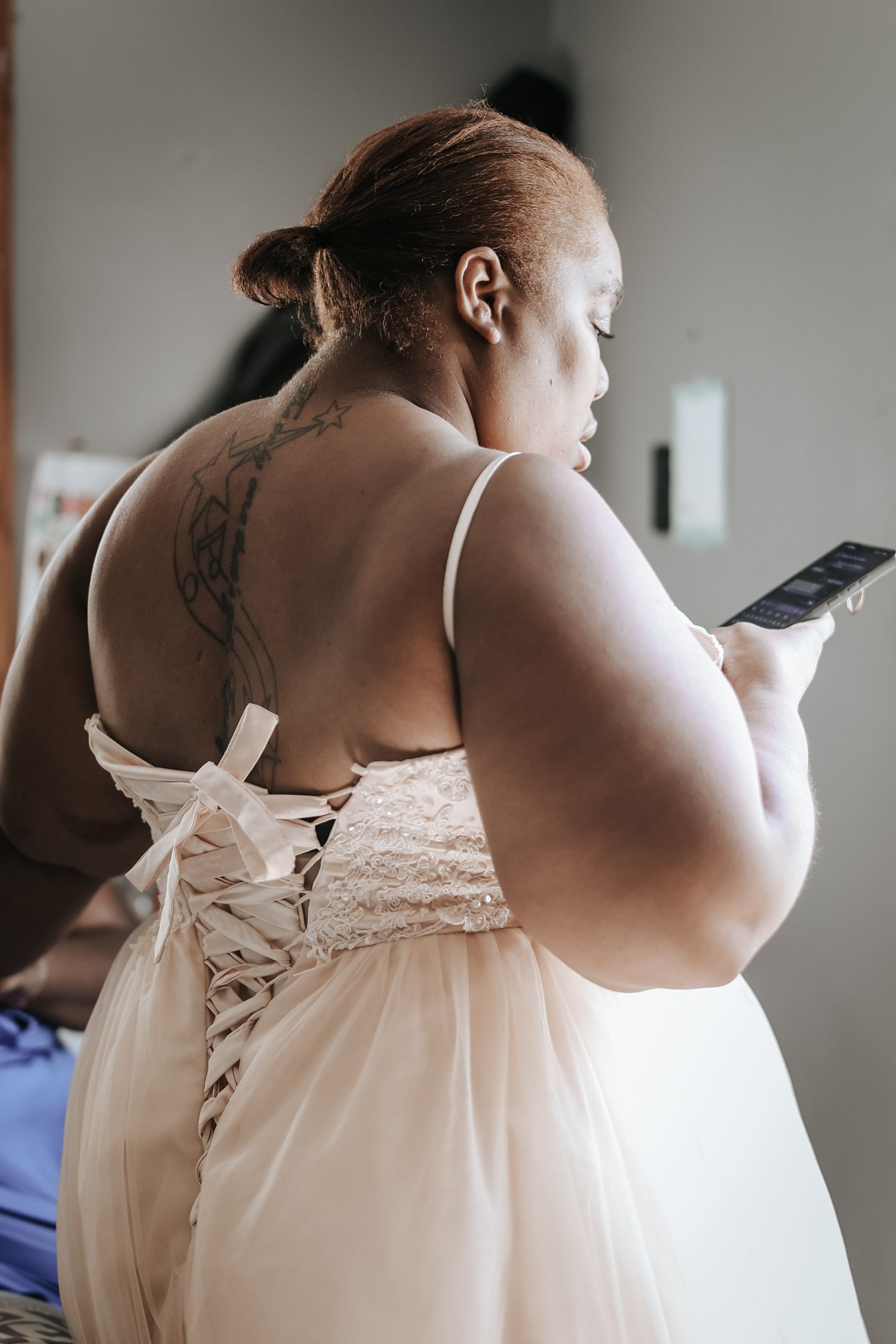 A series of close-up photos showing the back details of a white corset dress with lace-up ribbon detailing.