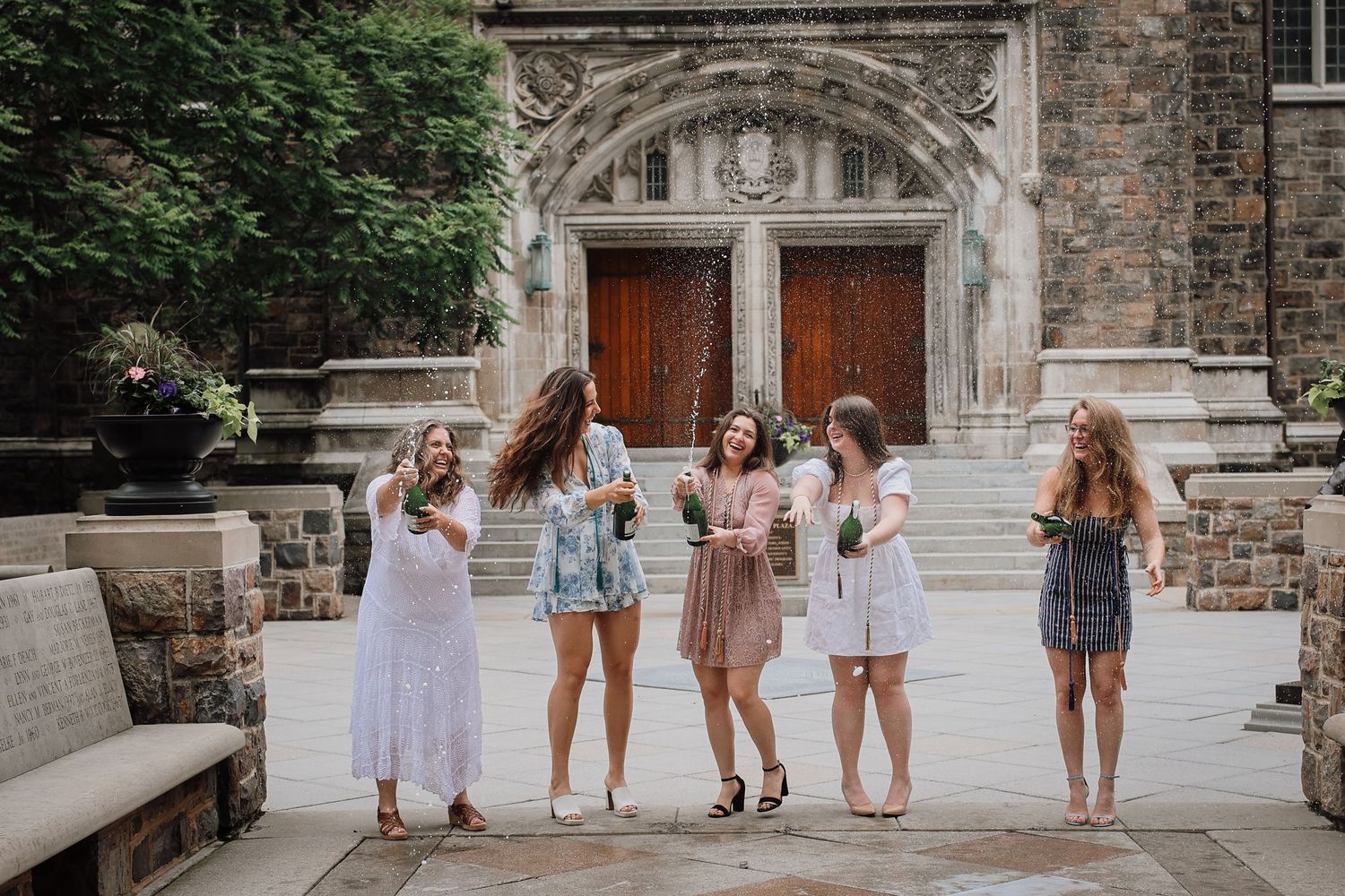 Group of friends walking together on a stone pathway outside a historic church building.
