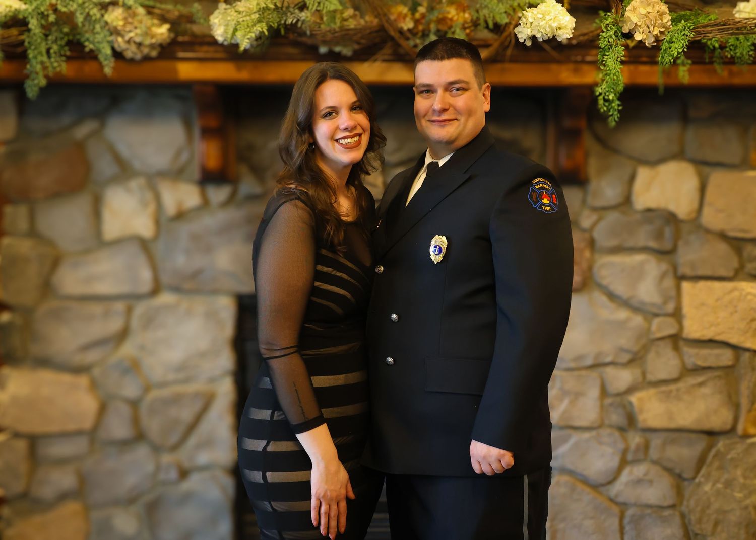 A couple poses together in formal attire against a stone wall background in multiple similar shots.