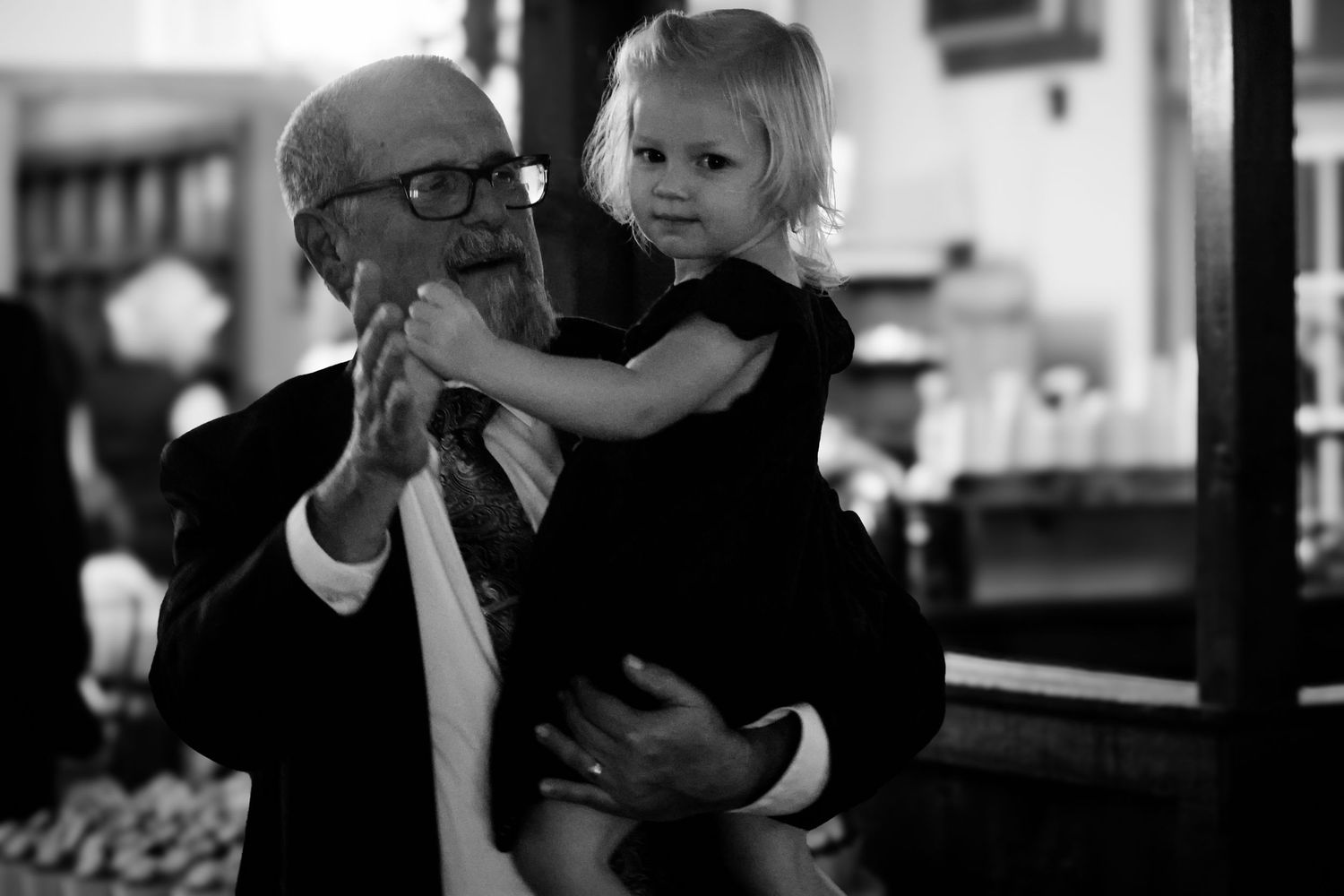 A series of black and white photographs showing intimate family moments between parent and child.