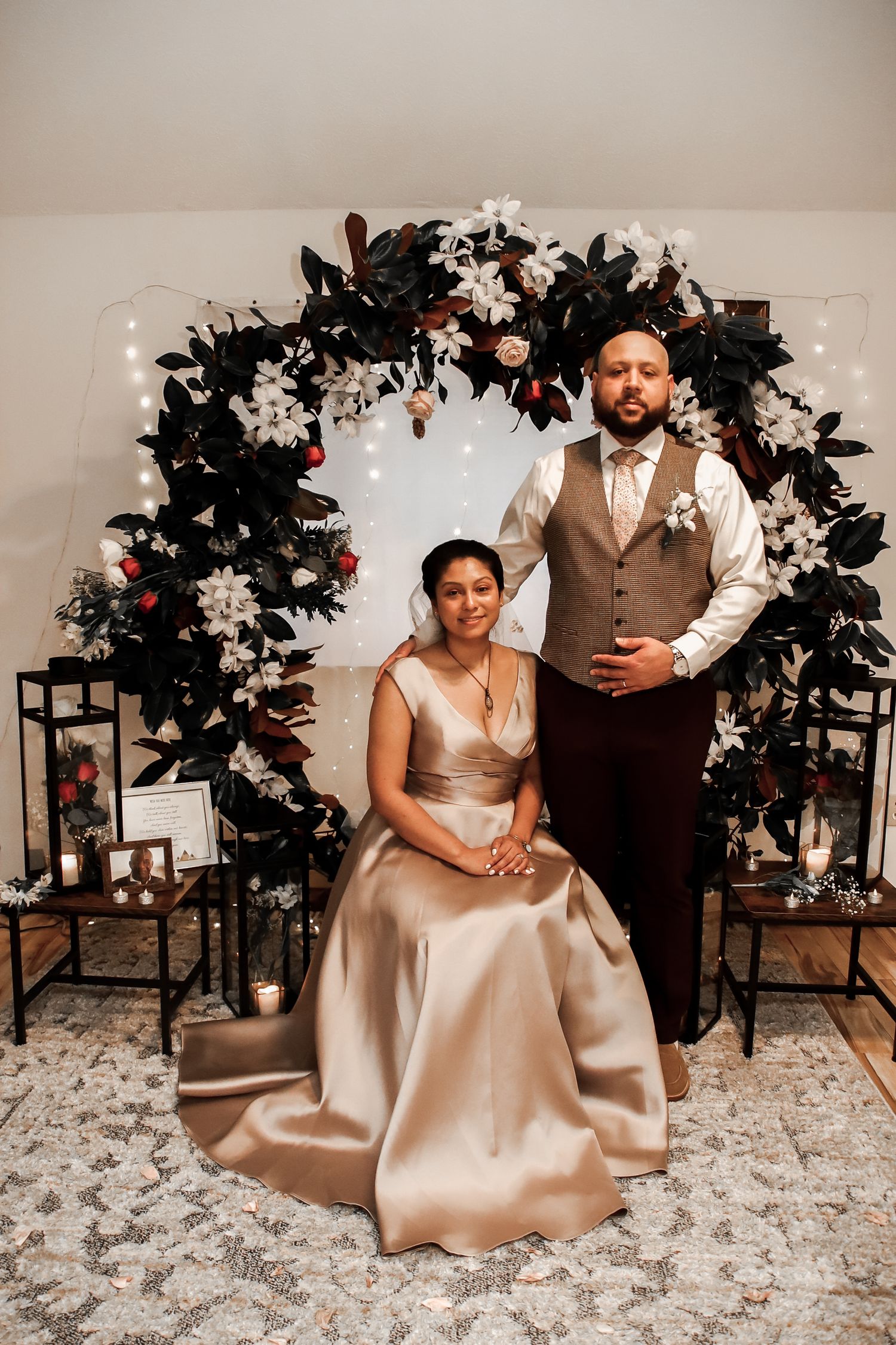 A romantic wedding photo series showing a couple posing together in elegant champagne and brown attire against a floral backdrop.