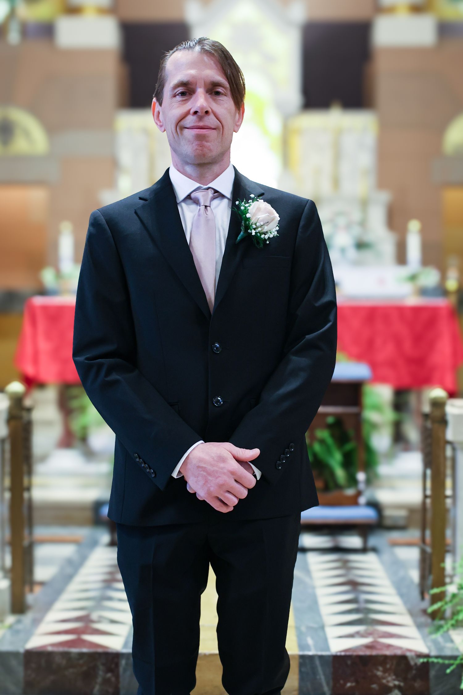 A series of five photos showing a groomsman in a black suit and tie standing in a formal event venue.