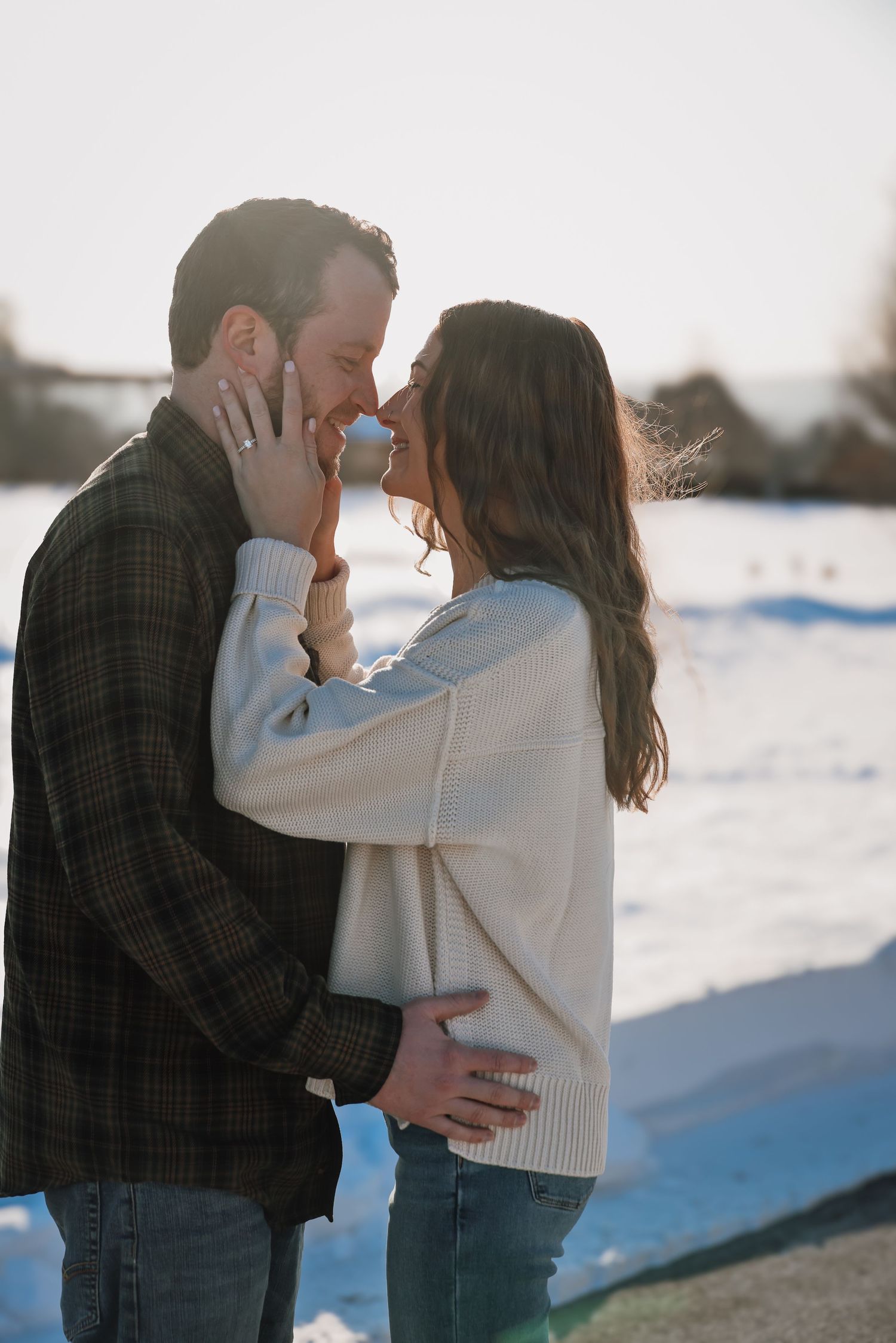 Romantic winter engagement photo sequence of couple embracing in snowy setting.