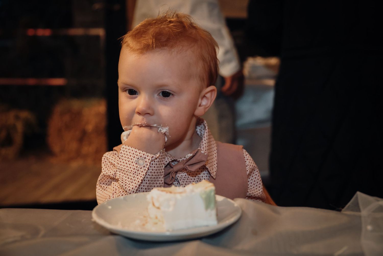 A series of photos showing a baby's first experience eating cake, progressing from curiosity to messy enjoyment.