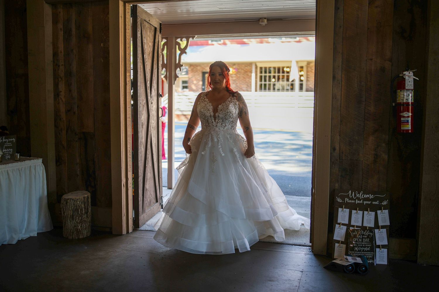 Wedding dresses displayed in a boutique storefront window with soft natural lighting.