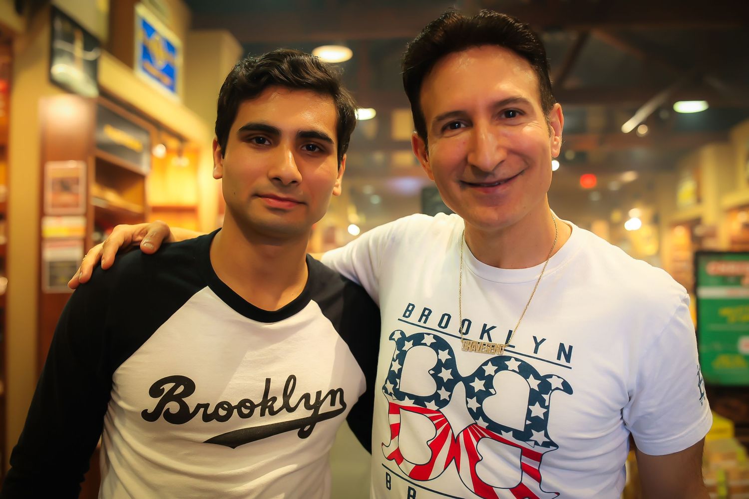 A group of people wearing Brooklyn-themed t-shirts pose together in a casual indoor setting.