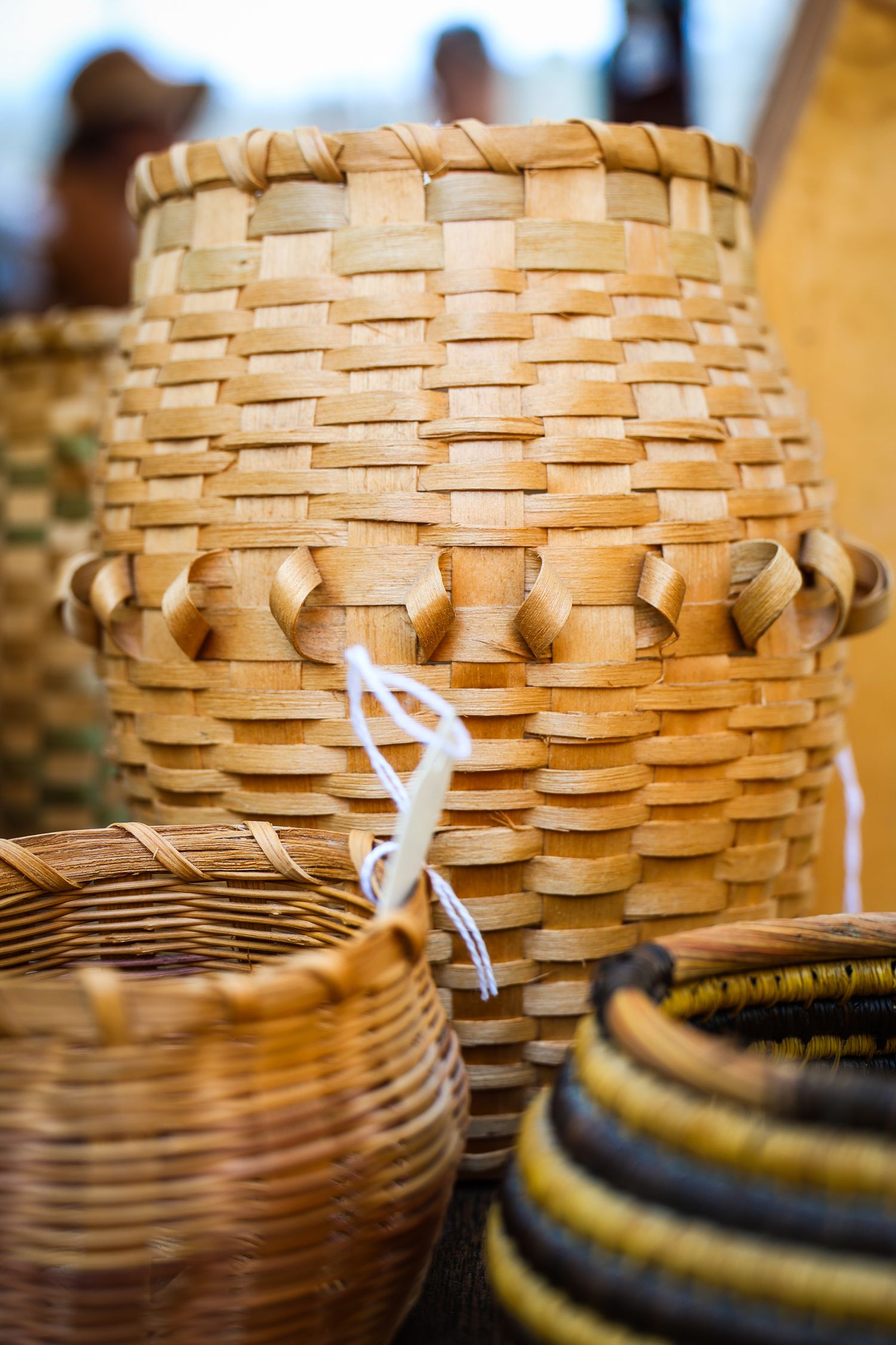 Close-up detail of woven basket patterns showing intricate natural wood textures and weaving techniques.