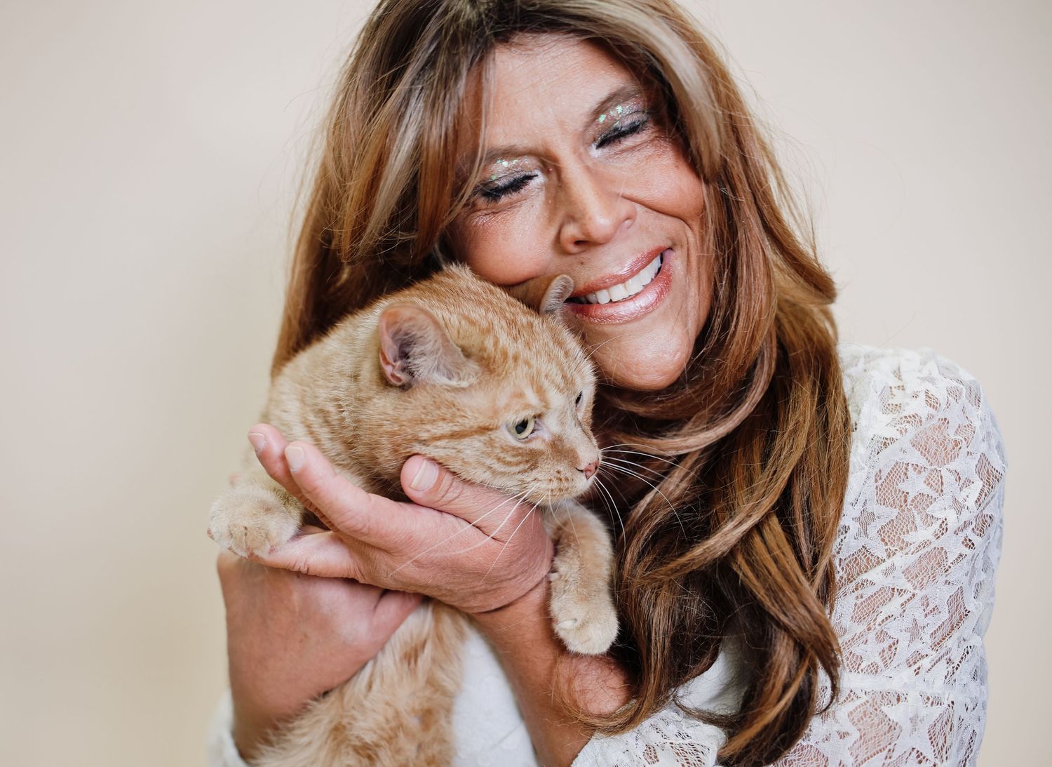 A series of photos showing a woman with long brown hair lovingly cuddling and playing with an orange cat.