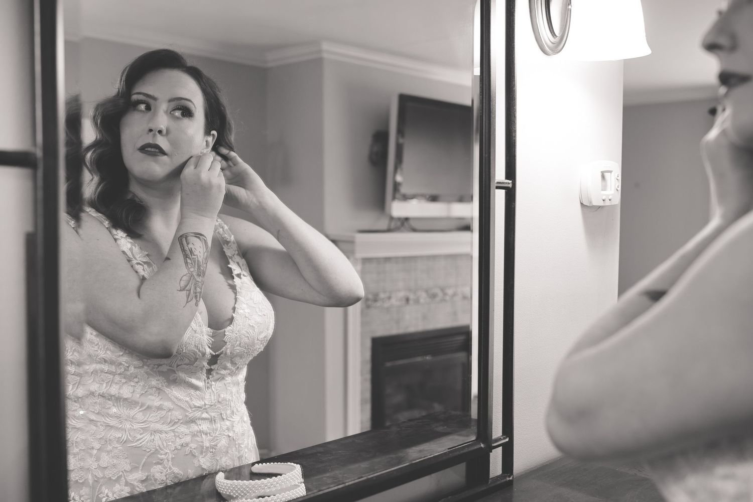 Black and white photo series of a person in vintage style dress and makeup getting ready at a vanity mirror.