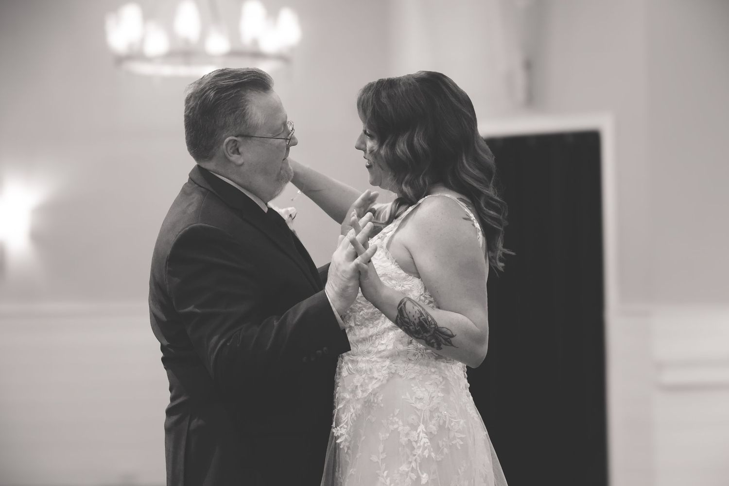 A black and white collage of romantic wedding moments showing couples embracing and kissing during their special day.