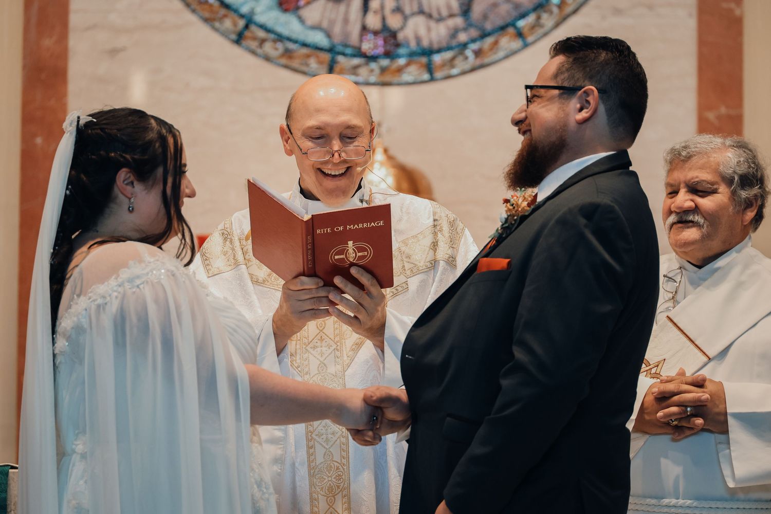 Wedding guests celebrate and dance together during a joyful reception at an indoor venue.