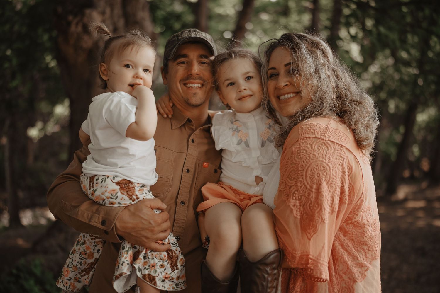 Family members share joyful moments together in a natural outdoor setting with warm autumn lighting.