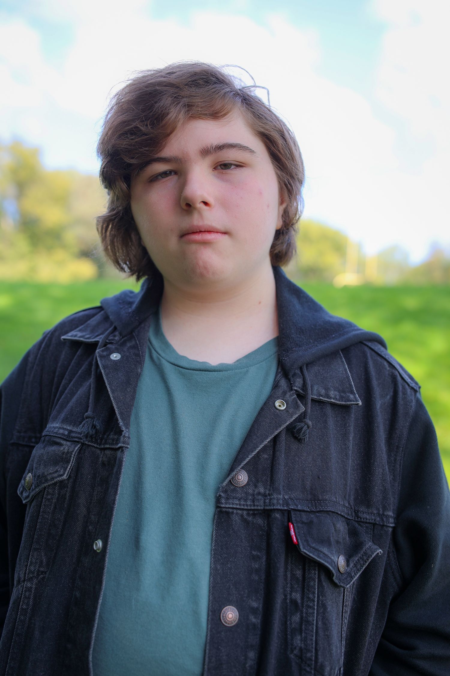 A series of similar photos showing someone in a black denim jacket and green shirt against a blurred outdoor background.