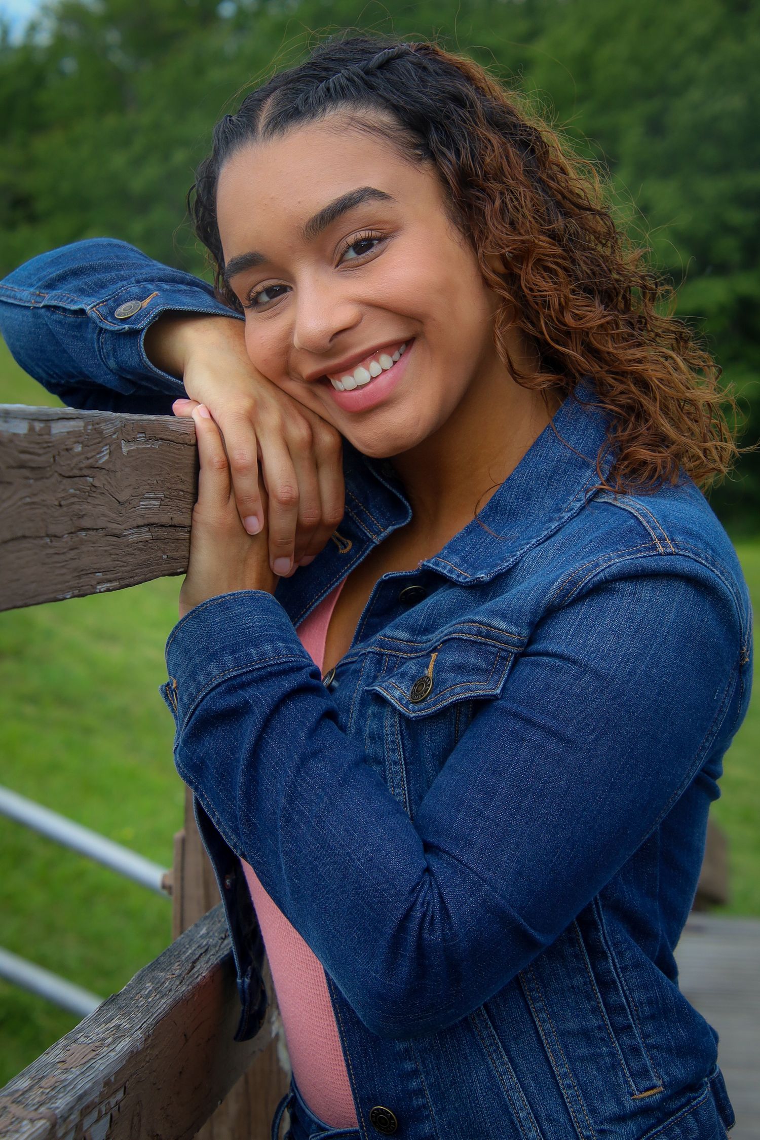 A series of outdoor portraits showing someone wearing a denim jacket and pink top posing against a natural background.