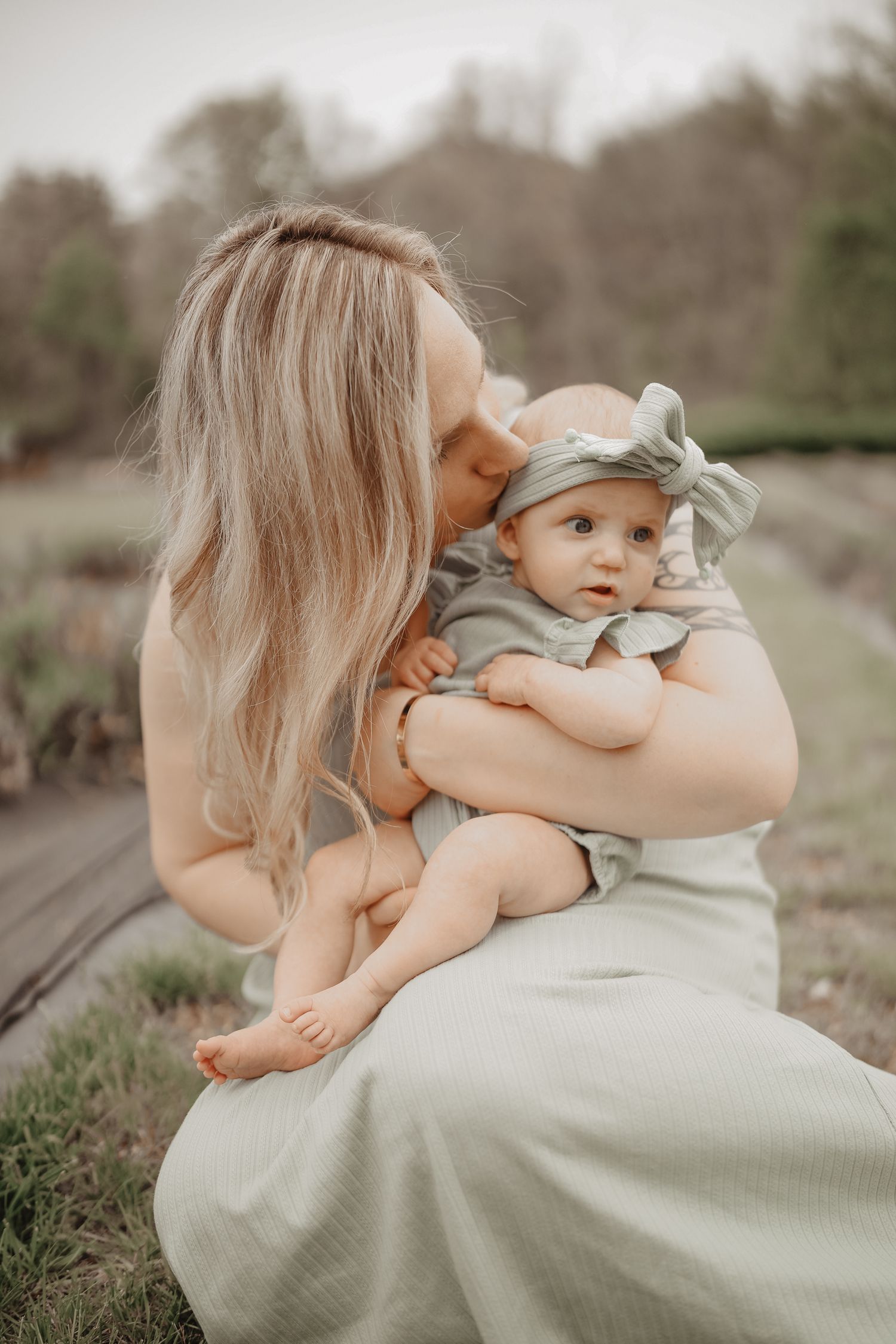 A tender moment between parent and child in soft sage green clothing captured in a series of connected outdoor photos.