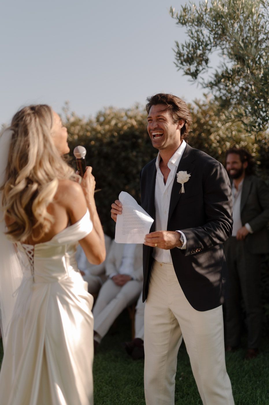 Wedding couple sharing joyful moment during outdoor celebration.