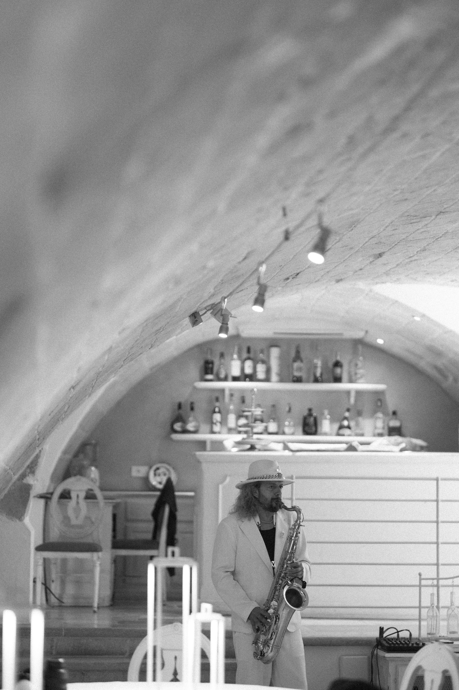 Interior view of an elegant vaulted room with white decor and arched ceiling.