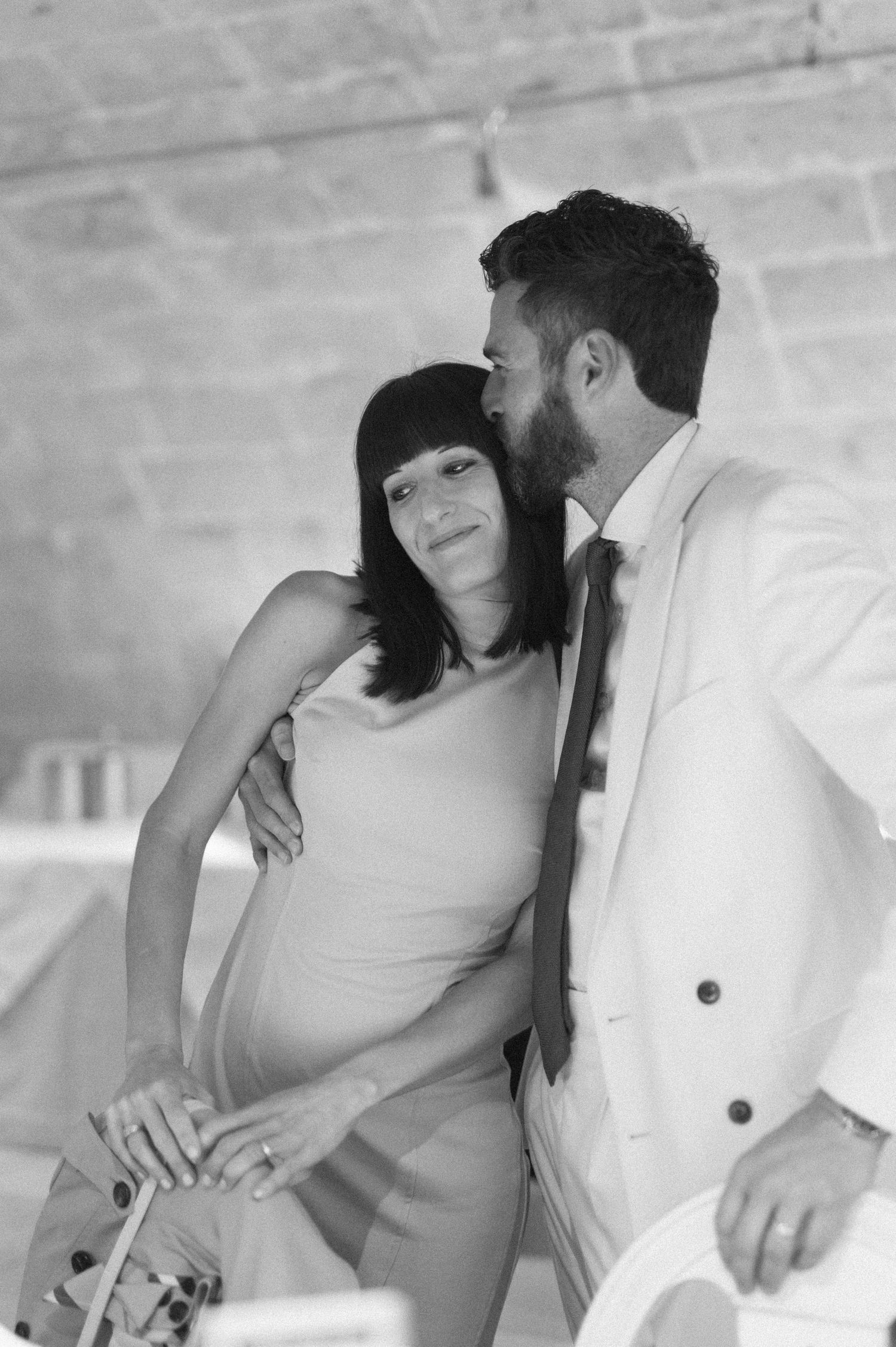 Intimate dance moment captured in black and white at an indoor wedding reception.