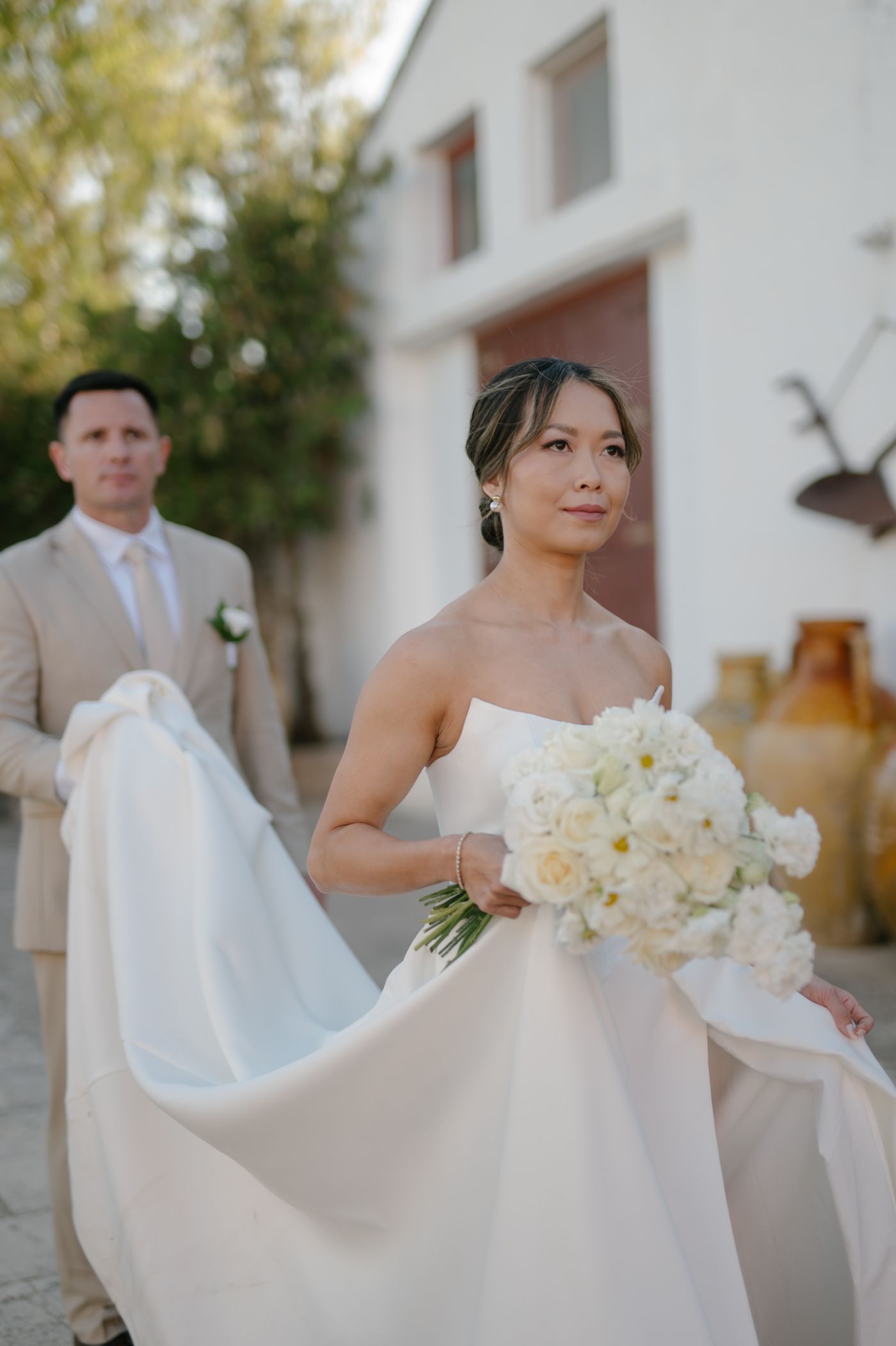 A series of elegant wedding photos featuring a white gown and bouquet against a light-colored building exterior.