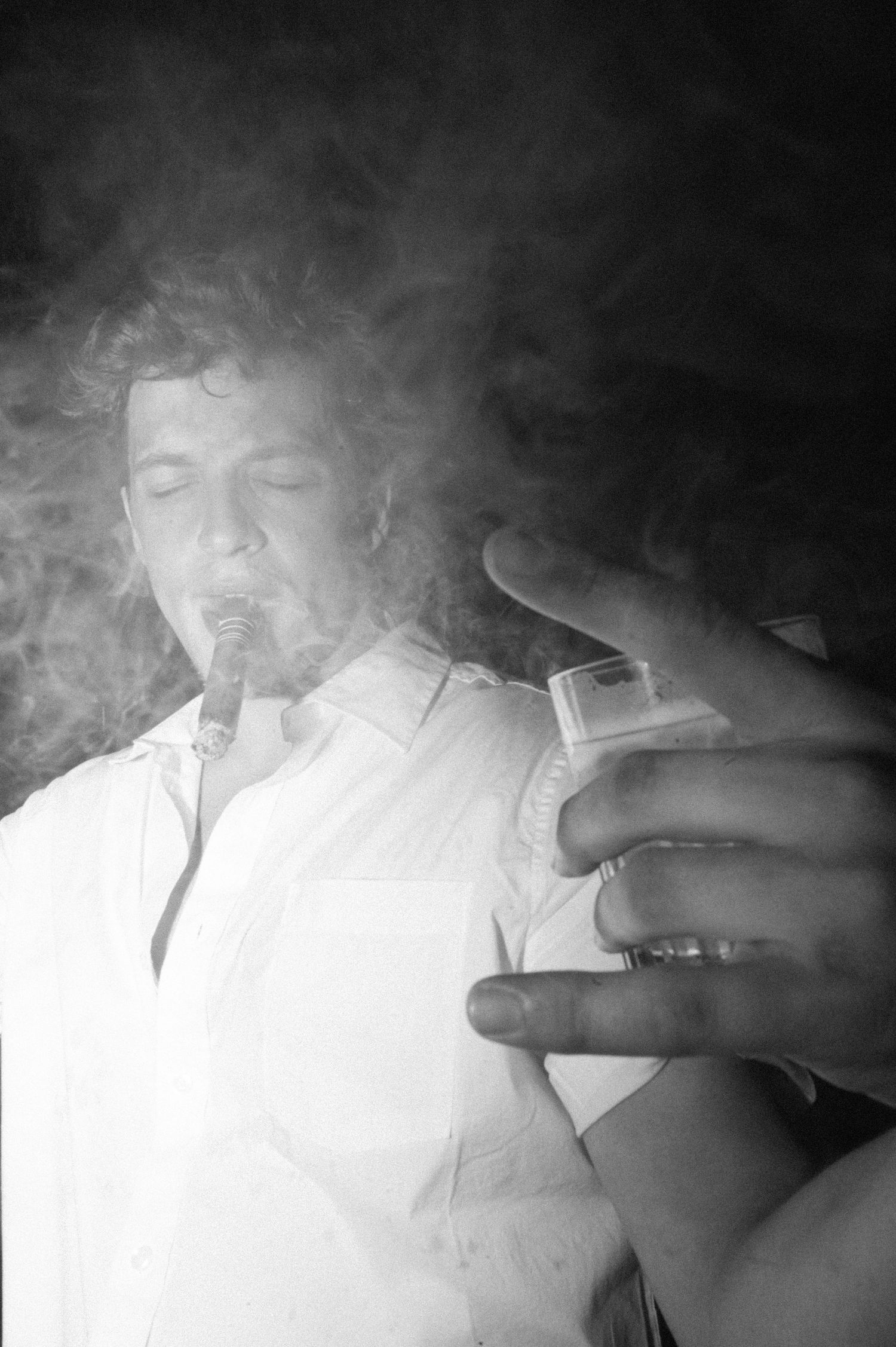 Smoky black and white portrait in dramatic lighting.