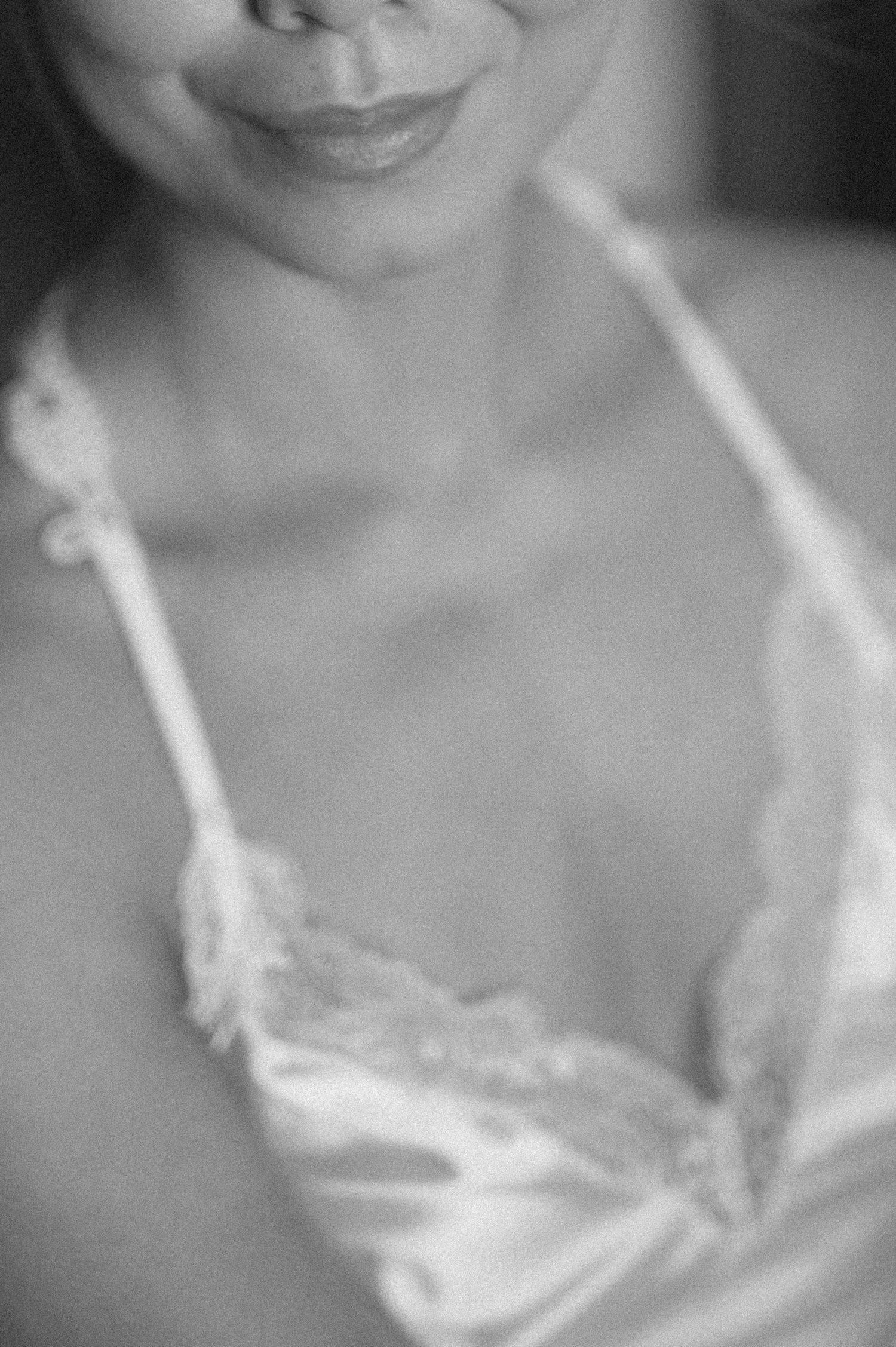 A black and white artistic portrait series showing close-up details of shoulders and neckline in soft lighting.