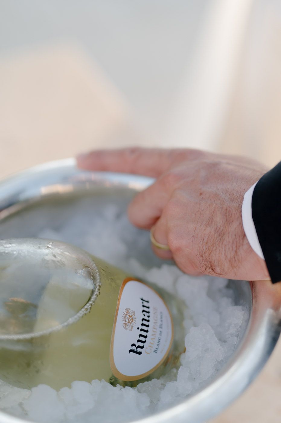 Chilled wine bottles resting in ice at an elegant event service.