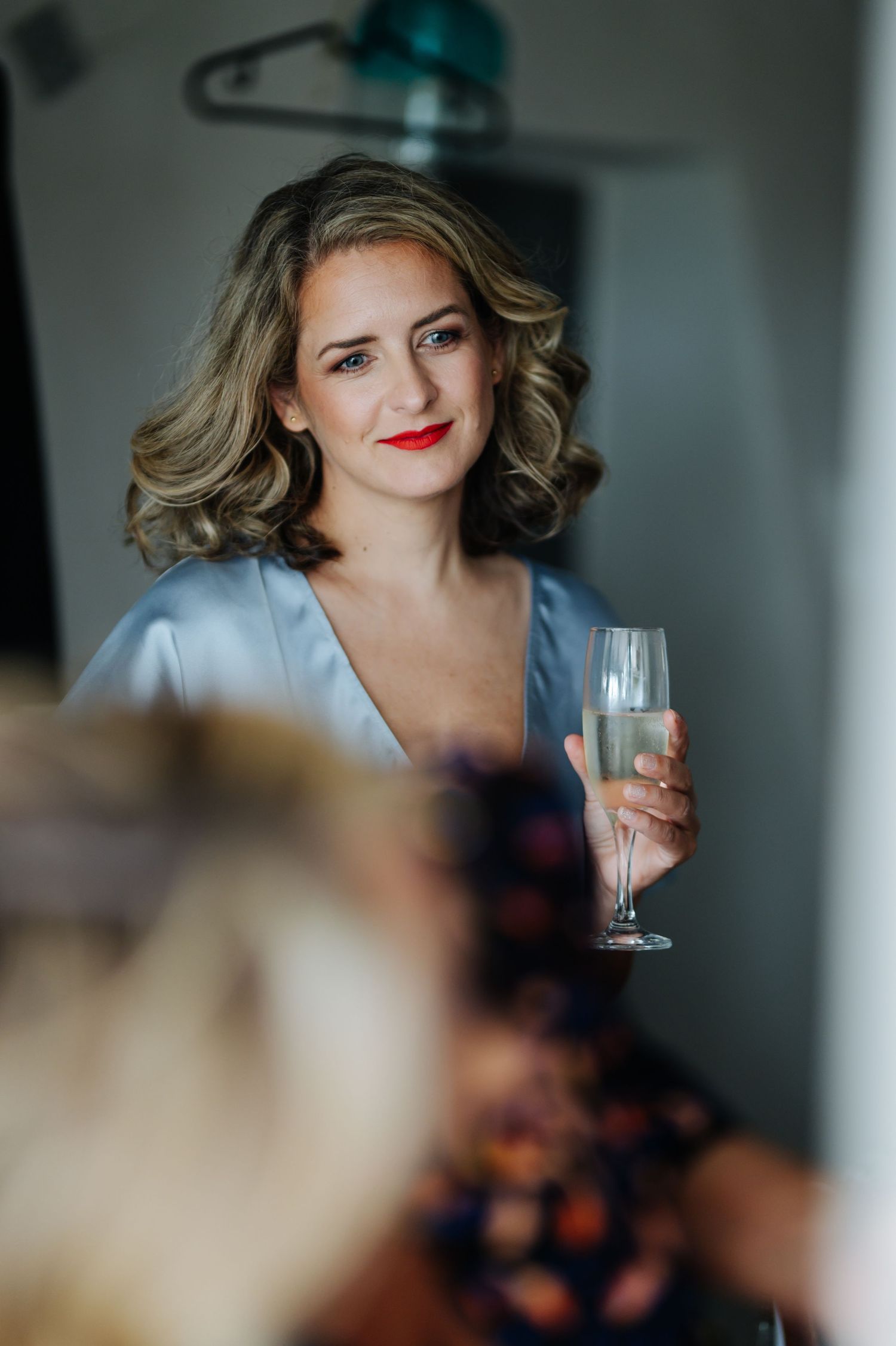 Elegant interior scene with champagne glass and soft lighting.