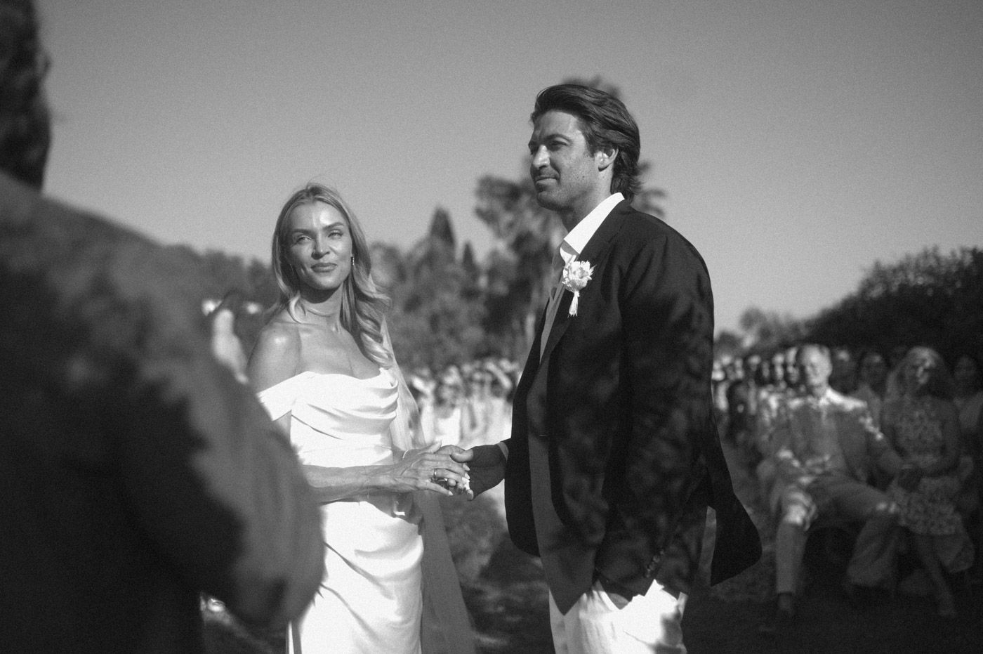 Black and white wedding ceremony photos showing guests and decor.
