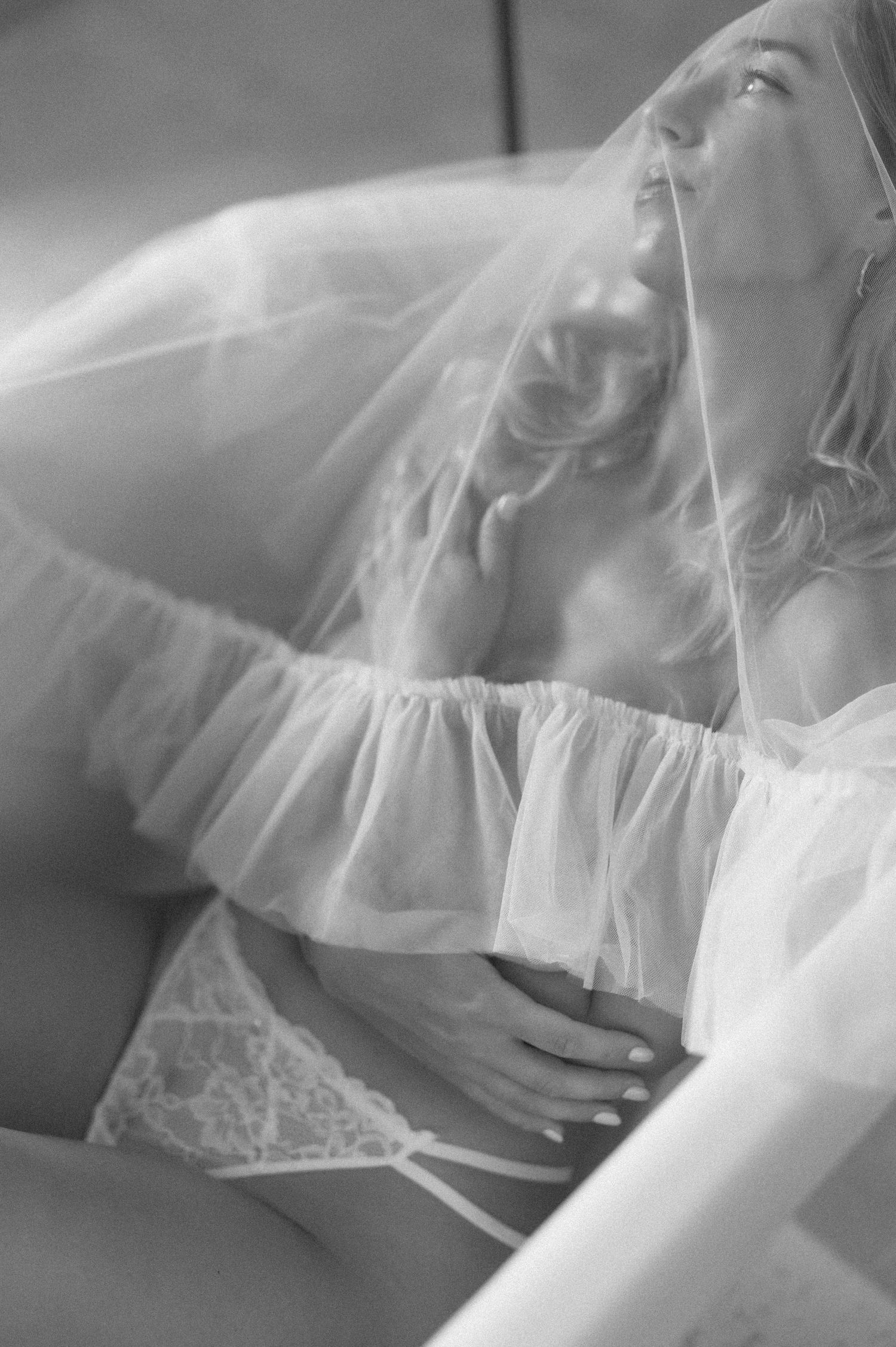Dreamy black and white photo of flowing white fabric and lace details.