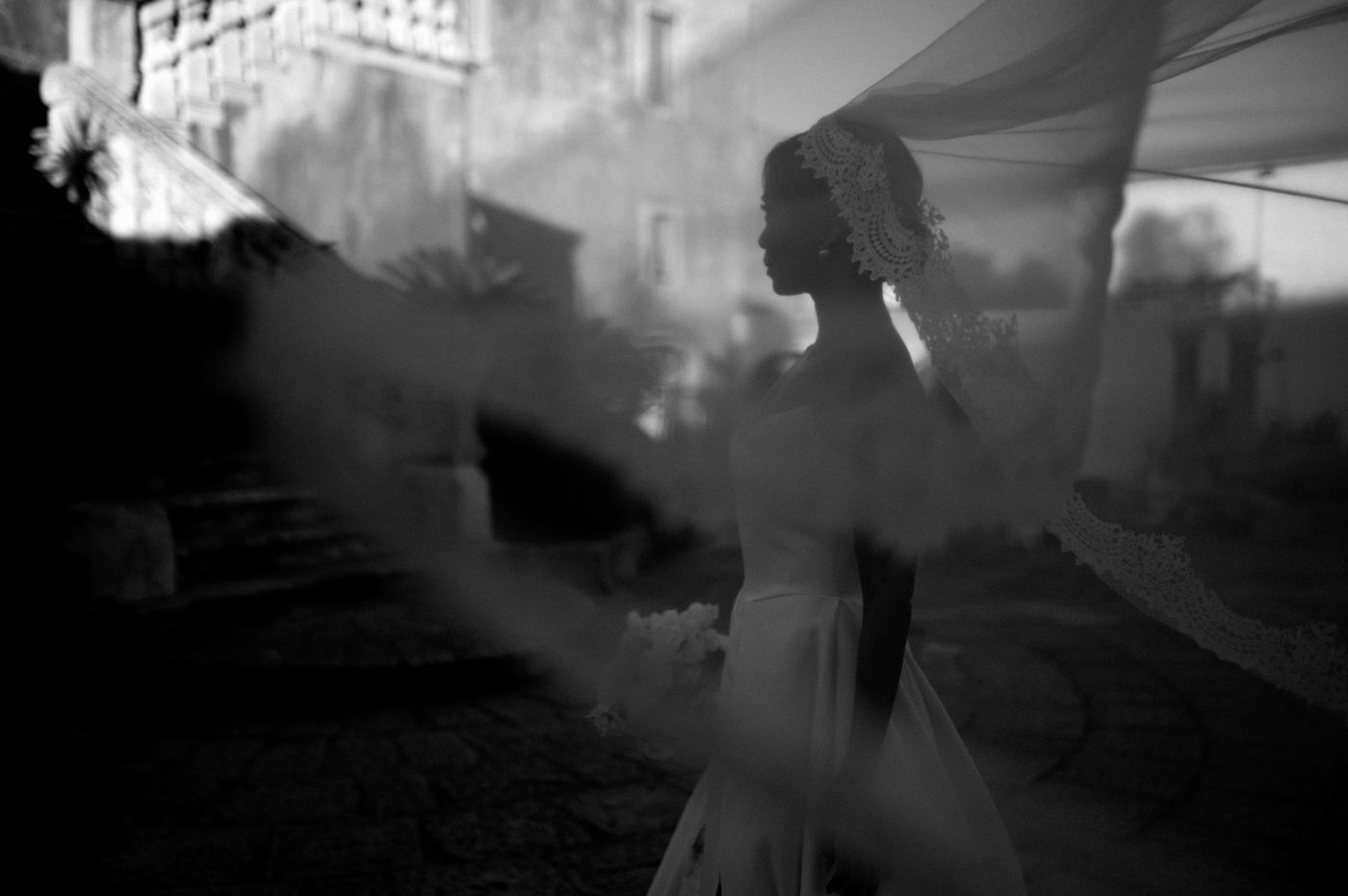A series of blurry black and white photographs showing abstract motion and movement in a dimly lit space.