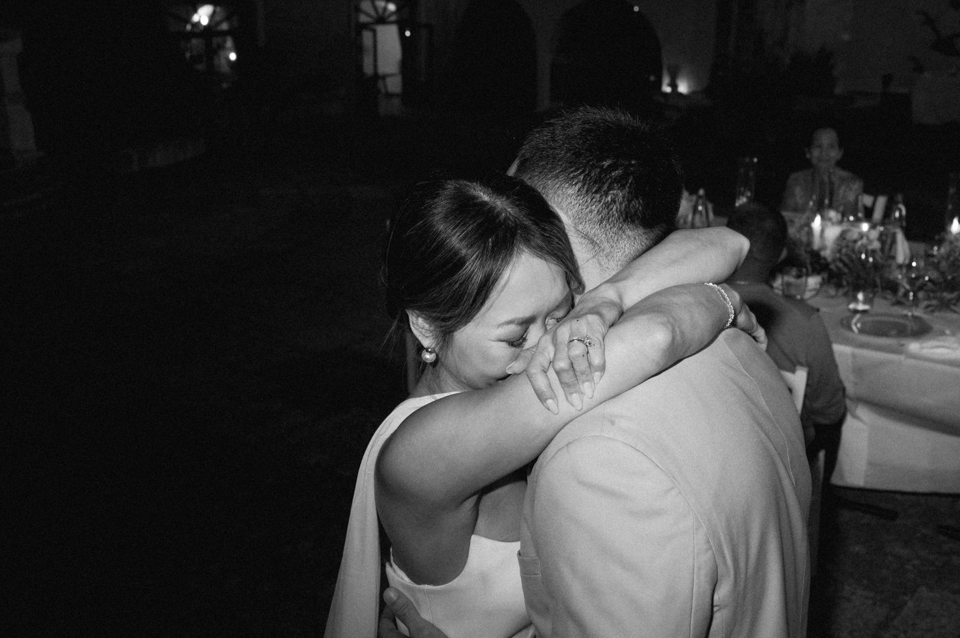 A series of seven black and white photos showing couples embracing and dancing at what appears to be a wedding reception.