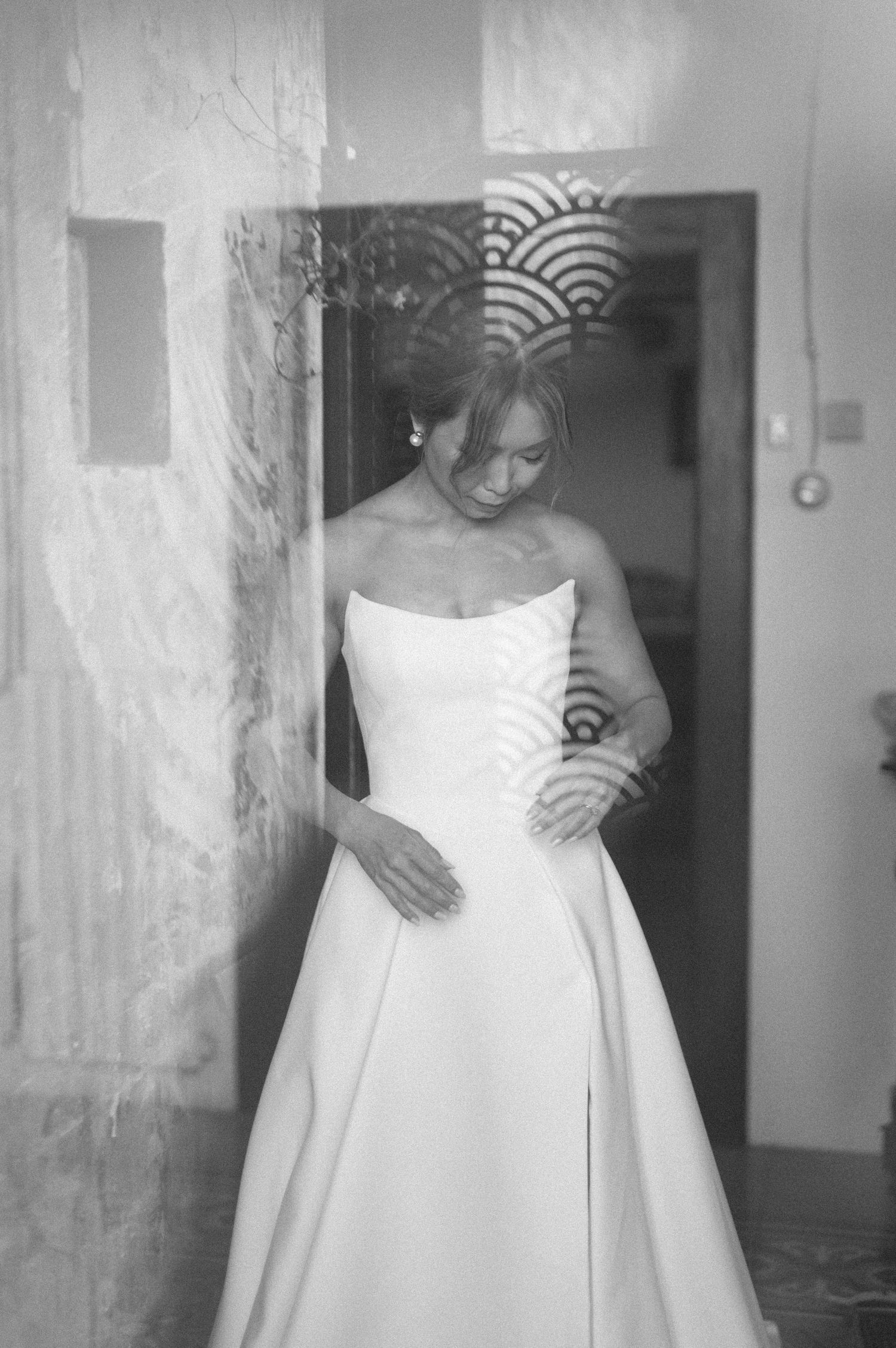 A series of black and white photos showing different angles of a strapless white wedding dress.