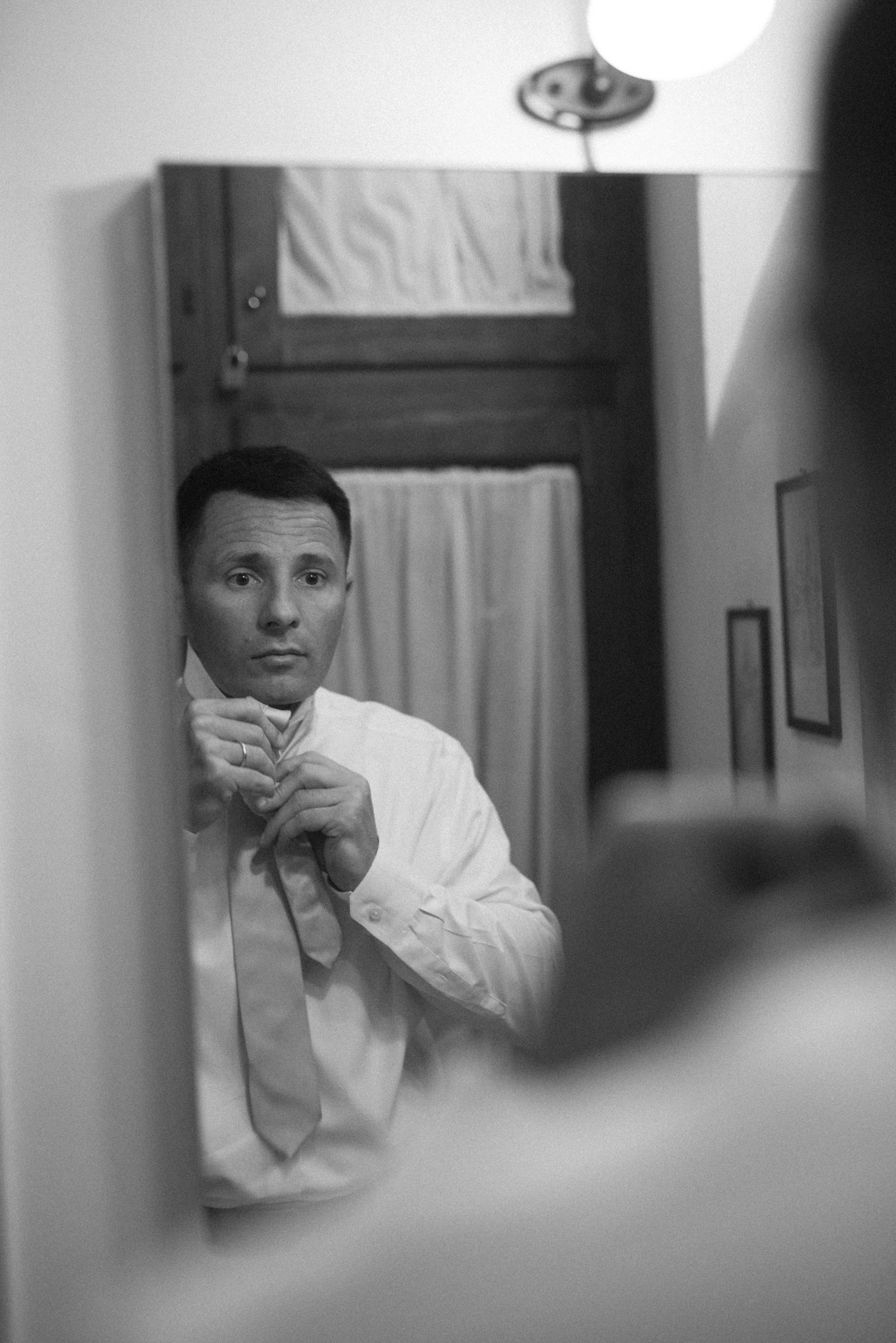 A sequence of black and white photos showing someone in a white chef's coat drinking from a cup.