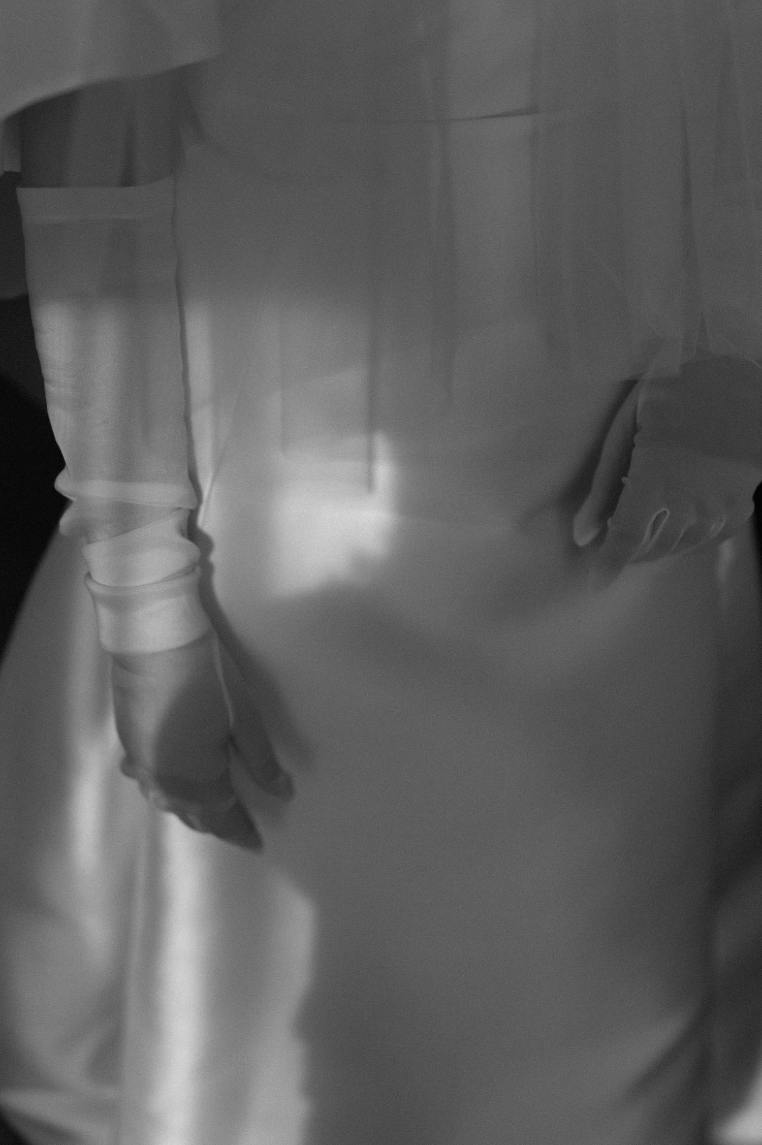 Artistic close-up of a classic white wedding dress details.