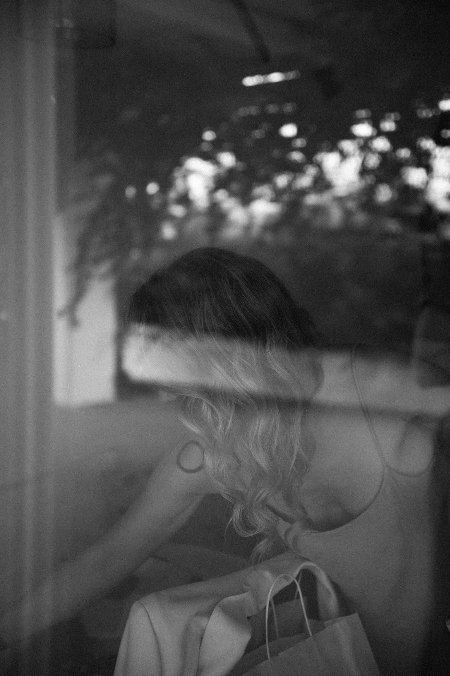 Artistic black and white photograph with bokeh light effects through glass.