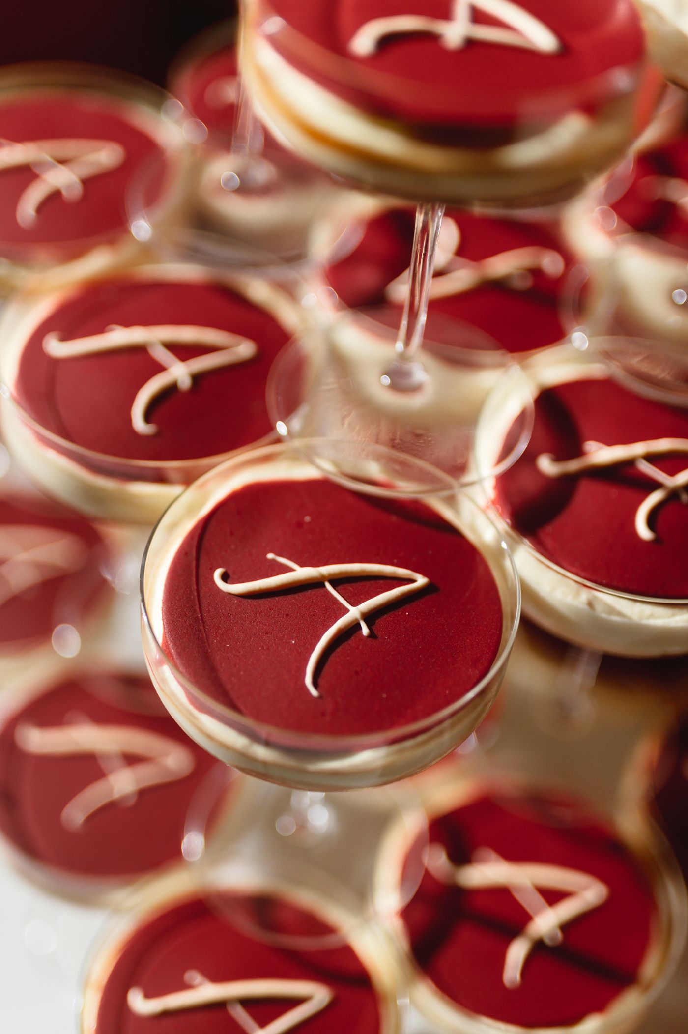 Red and white cookies decorated with Alabama Crimson Tide A logo arranged in neat rows.