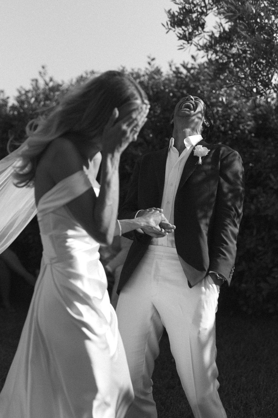 Wedding party dancing in black and white photography.