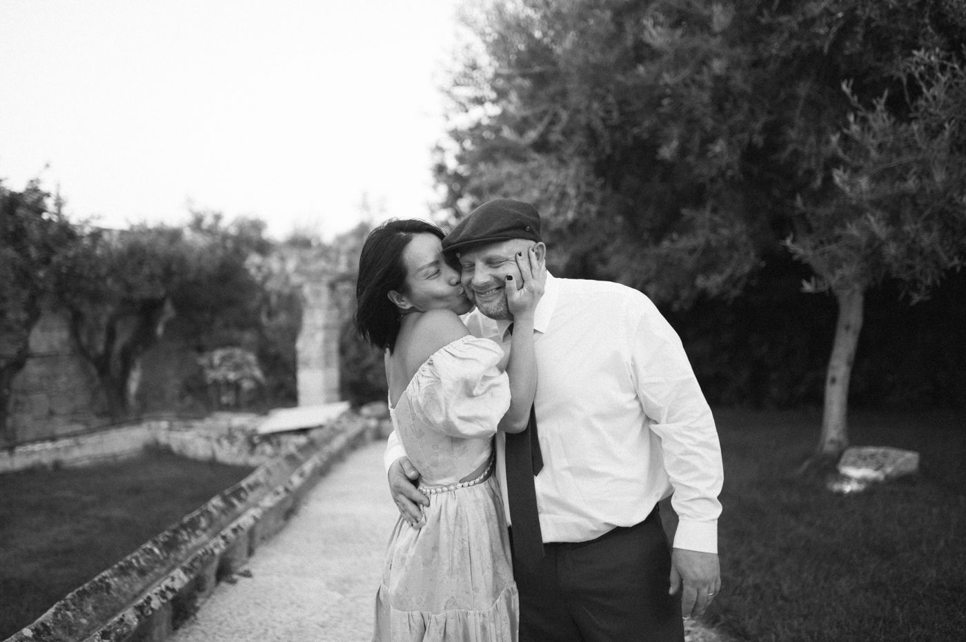 A black and white photo collage showing intimate wedding moments in an outdoor garden setting.
