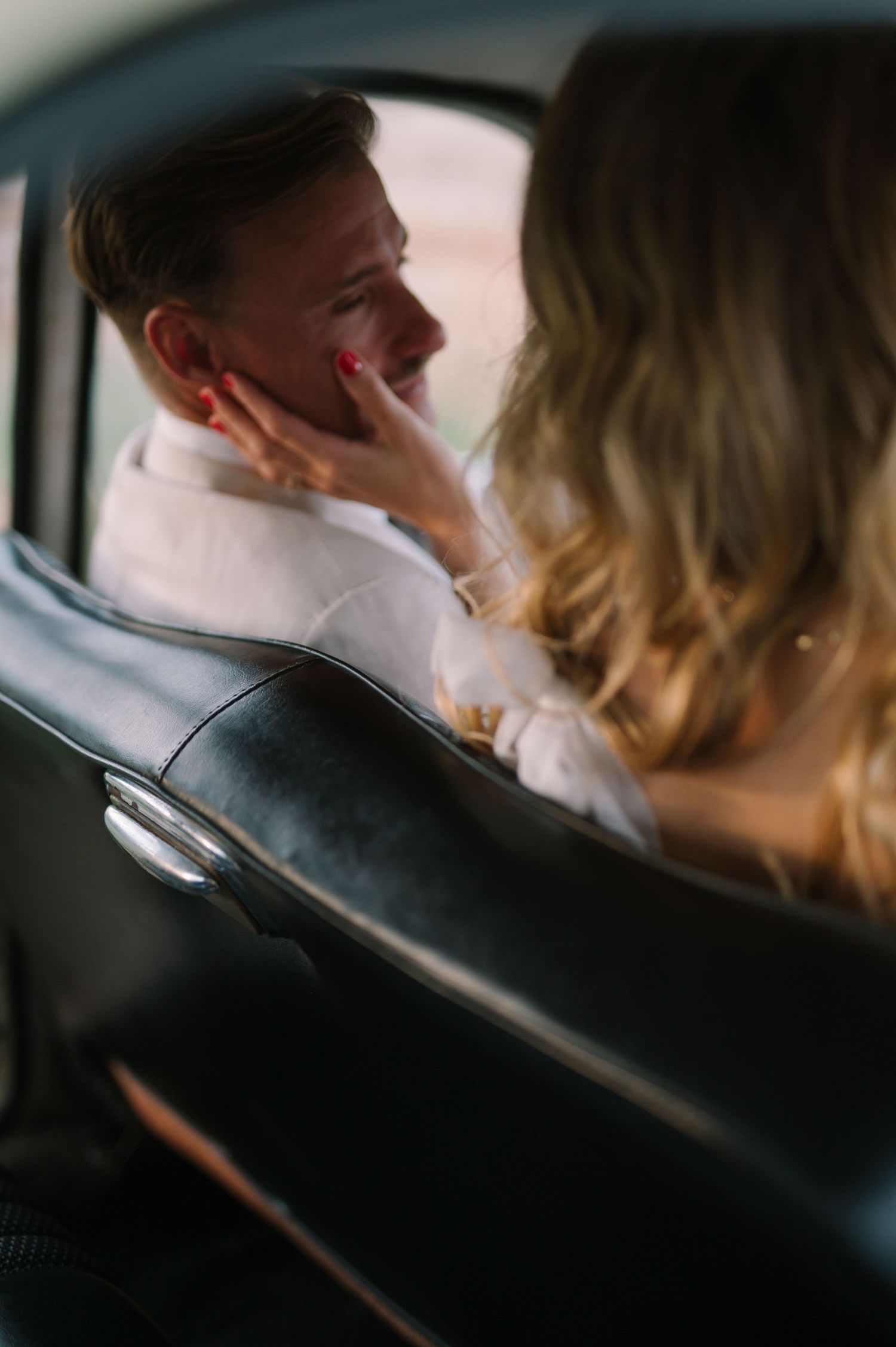 Candid sequence of newlyweds sharing a moment inside a car.