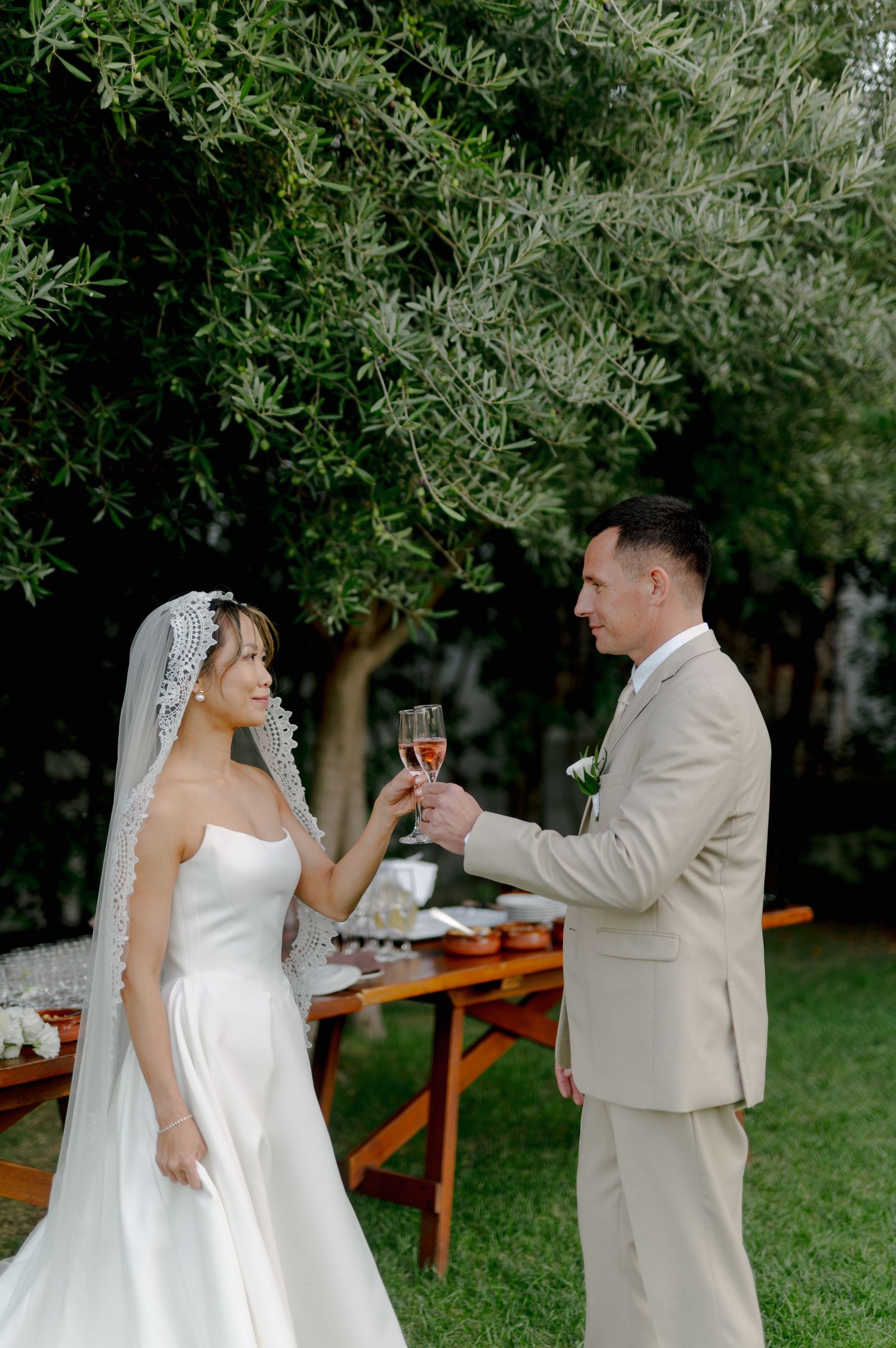 A sequence of wedding photos showing the bride and groom enjoying drinks and candid moments in a garden setting.