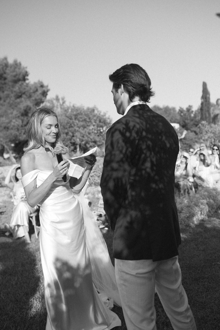 Black and white photos capturing candid moments at outdoor wedding.