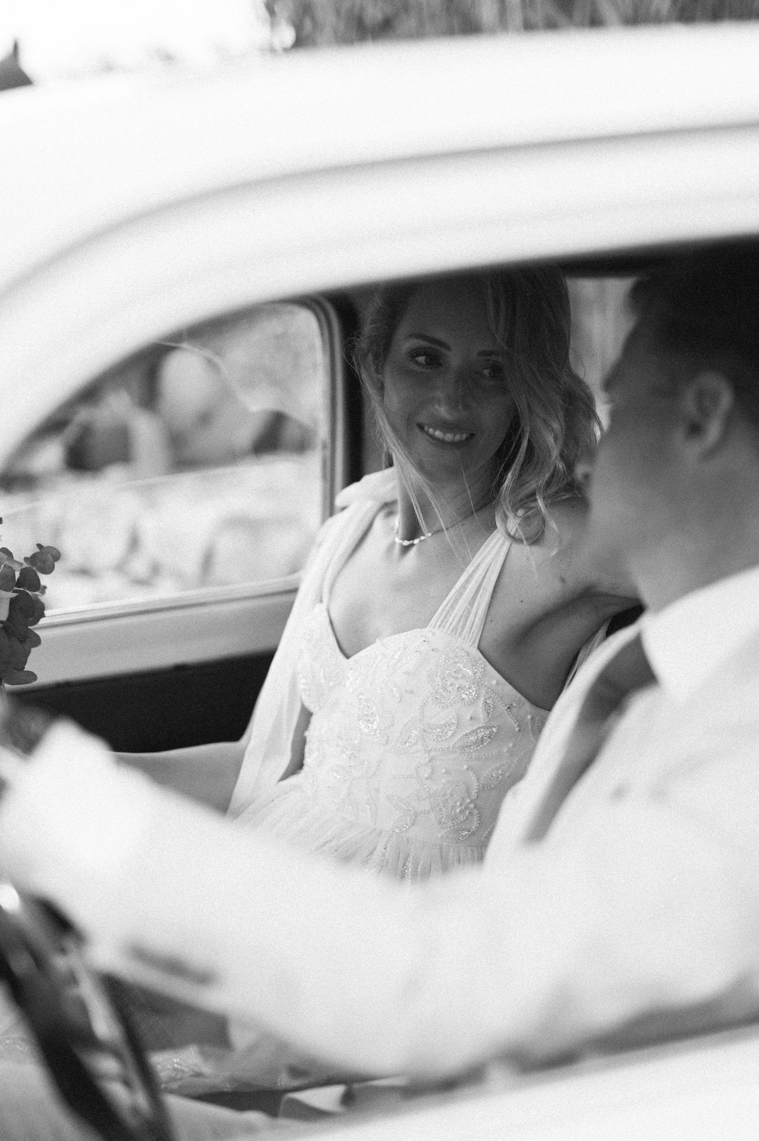 A series of black and white photos showing a couple in a car on their wedding day.