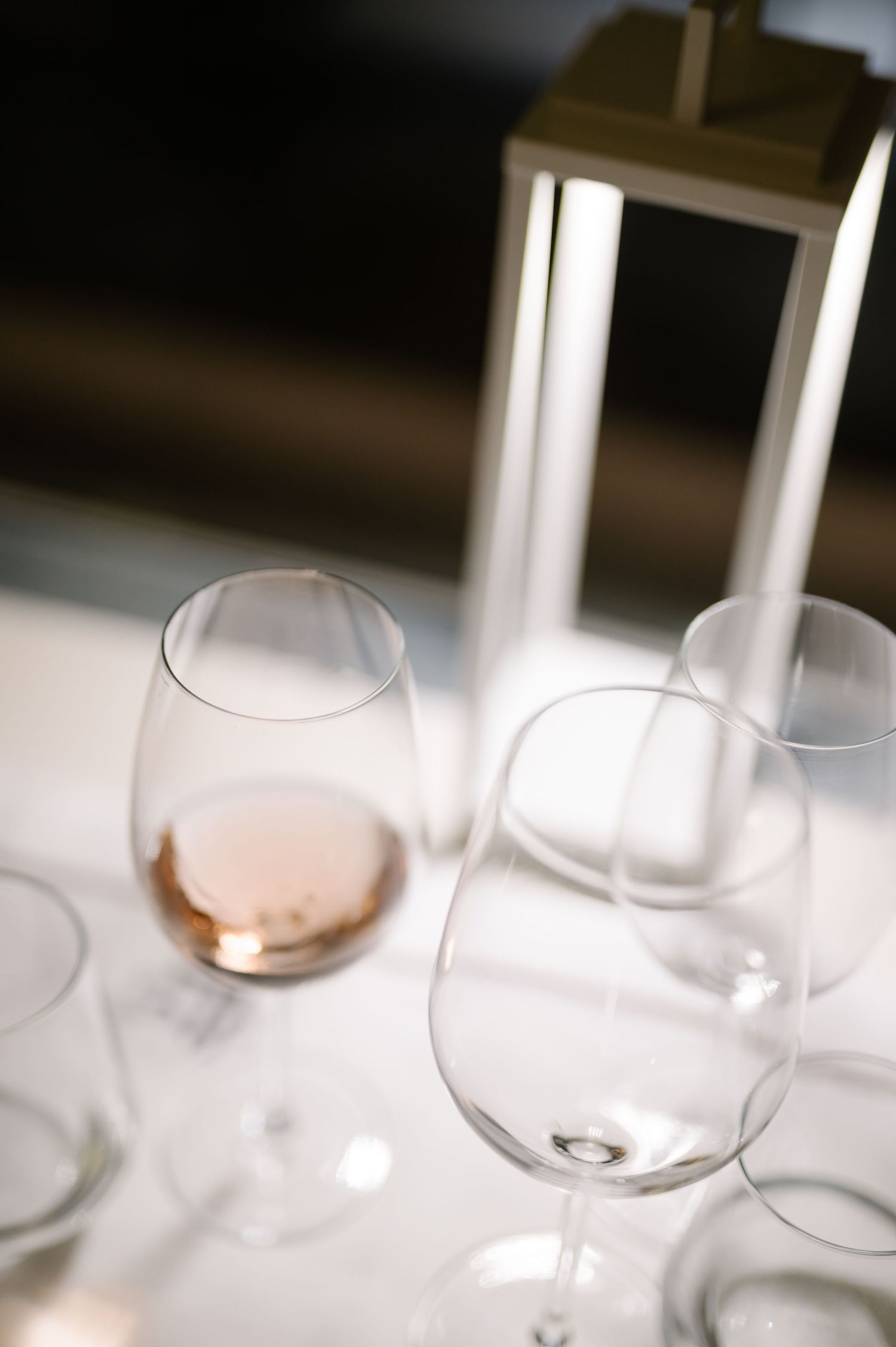 Artistic close-up of empty wine glasses on an elegant dining table.