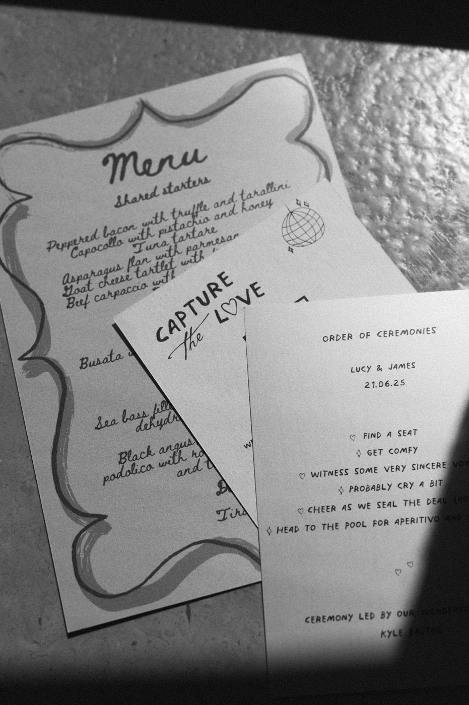 Black and white wedding ceremony program cards with elegant script text.