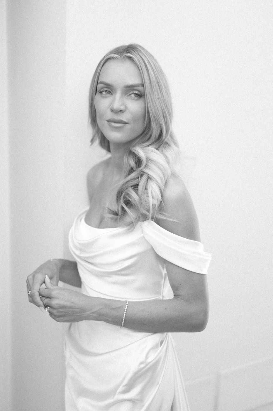 Artistic black and white fashion portraits showing elegant movement with white fabric against light background.