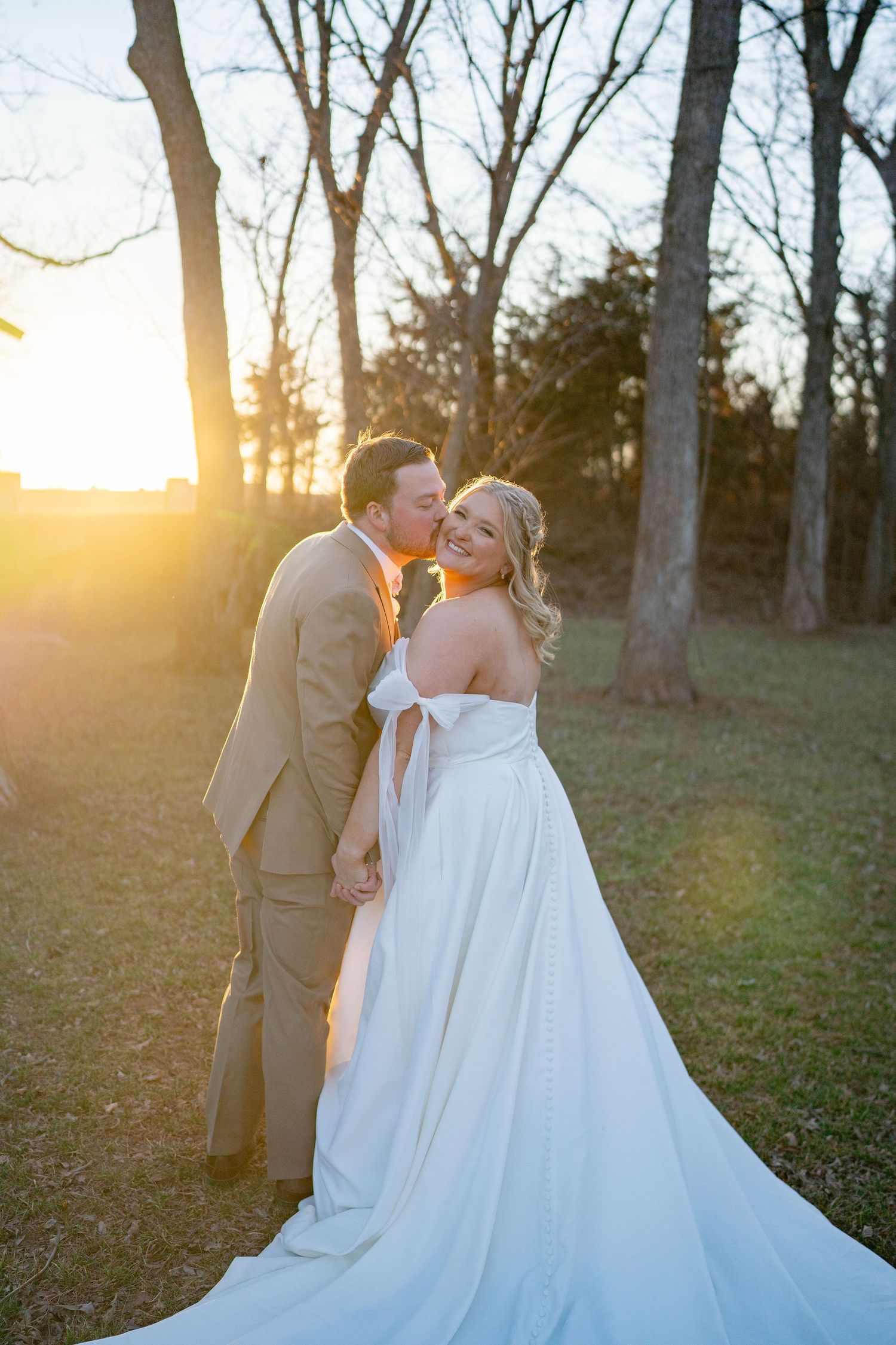 A romantic sunset wedding photo session in a wooded area with warm golden light.