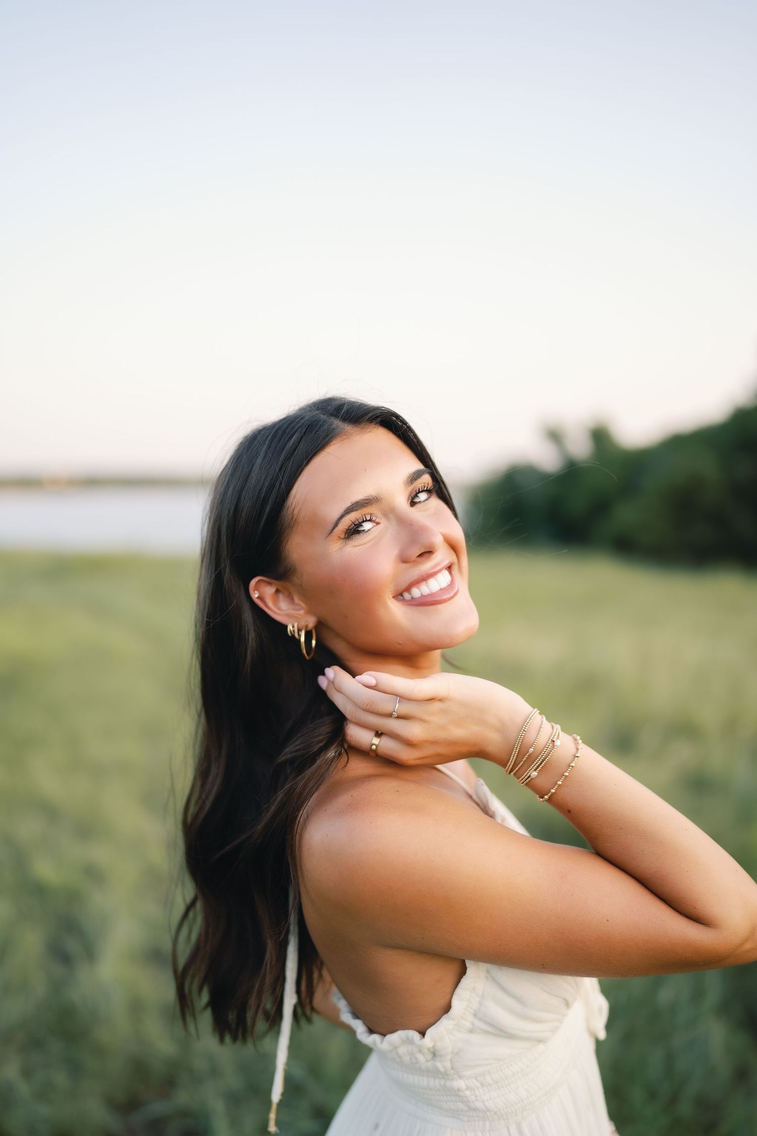 Natural light portraits captured in a serene field during sunset.